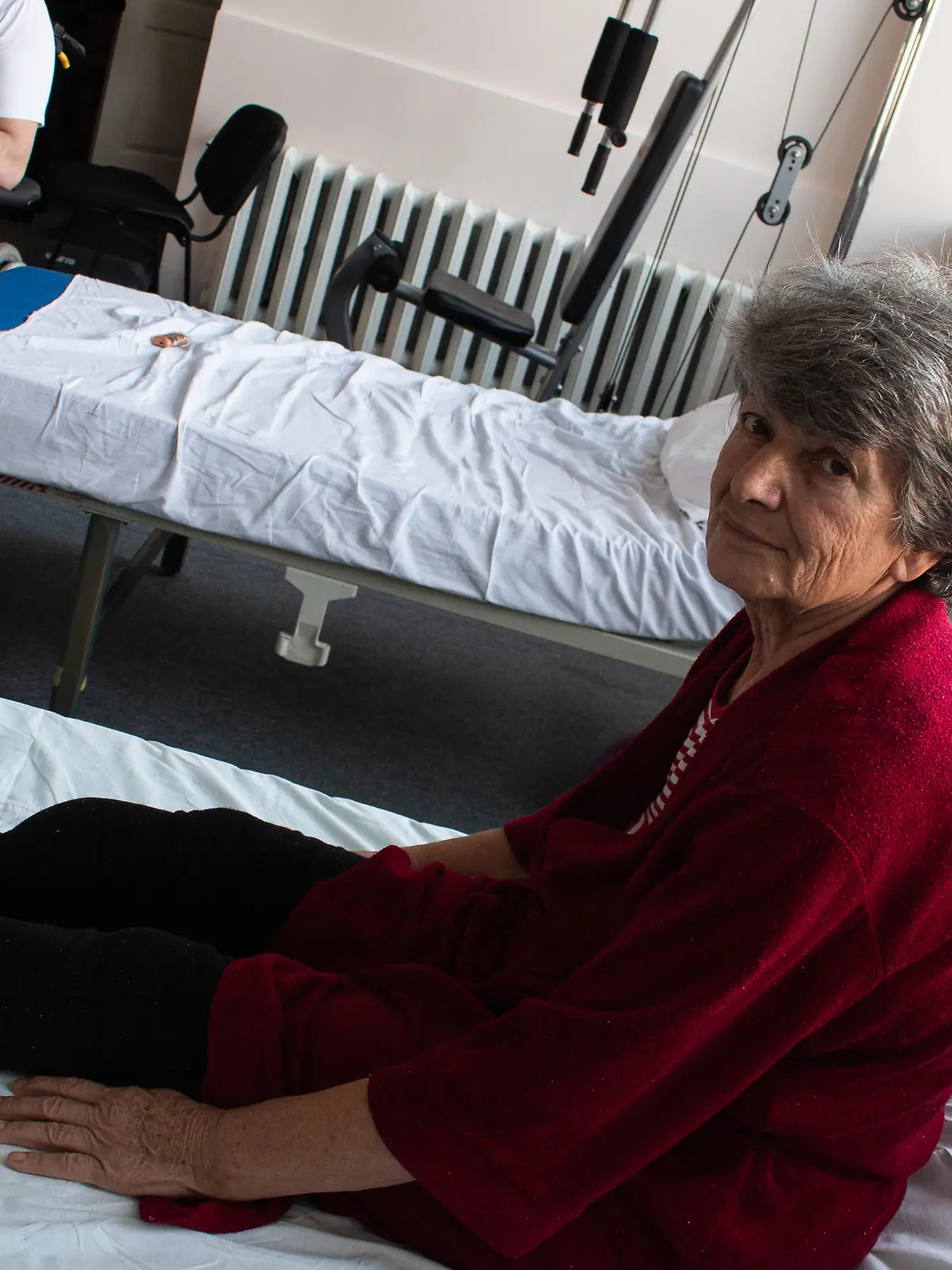 Tetyana Voytenko, a patient with an amputated right leg, from Izyum, Kharkiv region.  She is being treated by MSF physiotherapists in Vinnytsia.

"When the Russians fled from Izyum, they covered the whole city with tiny petal mines: backyards, gardens and walking paths. I go to the forest to collect firewood so that I could use as a source for heating. It wasn't the first time I walked that path but it was the time when I stepped on that petal mine. Half of the right leg was torn off. I was together with my neighbor Nadia, and her goats. They walked ahead, passing all the trouble but it didn’t pass me. I keep feeling severe phantom pains, but when the wound heals, I will ask for a prosthesis, for now - I can move around only on crutches.