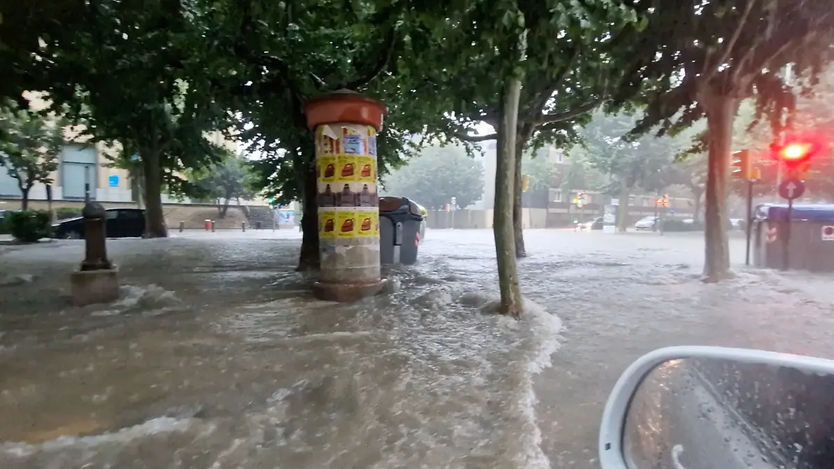Flood water flows as it rains in Igualada, Spain July 12, 2025 in this screengrab obtained from a social media video. Jordi Miserachs/via REUTERS  THIS IMAGE HAS BEEN SUPPLIED BY A THIRD PARTY. MANDATORY CREDIT. NO RESALES. NO ARCHIVES.  VERIFICATION - Road layout, trees, buildings’ facades, street lights and businesses logos that match file and satellite imagery - Coordinates included in original file metadata - Date was verified by original file metadata 