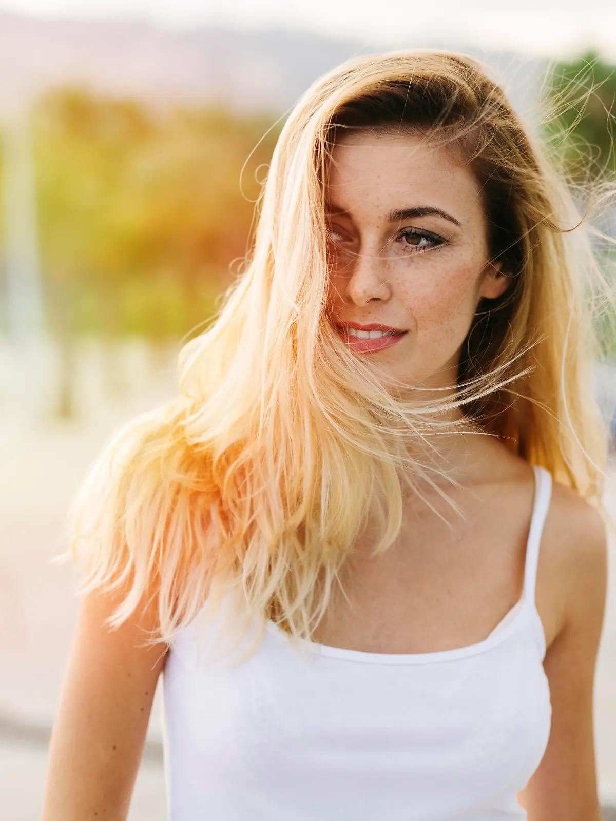 Beautiful woman looking away and with hair blowing in the wind.