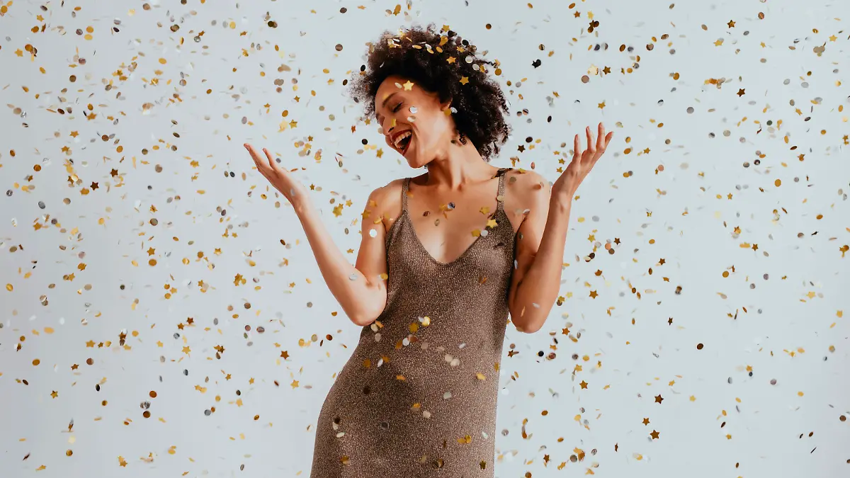 Beautiful smiling smartly-dressed woman dancing at a wedding reception
