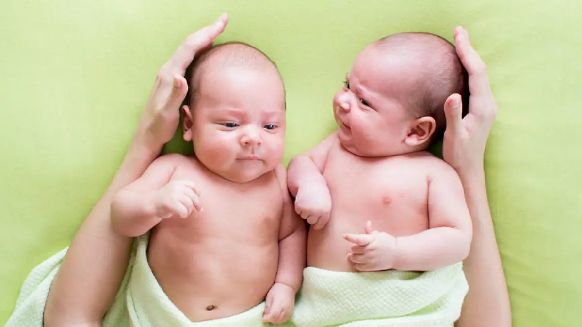 caring mother embracing twins babies