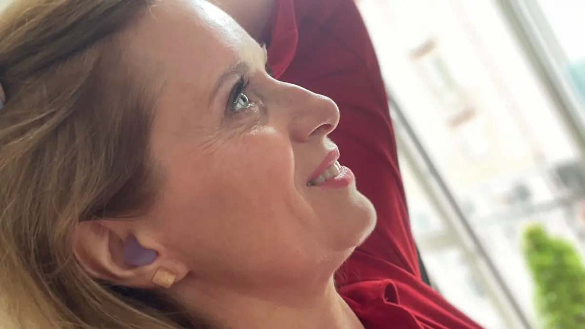 Profil der Redakteurin Maren Mangold mit einem Silikon-Ohrstöpsel vor dem Gehörgang.