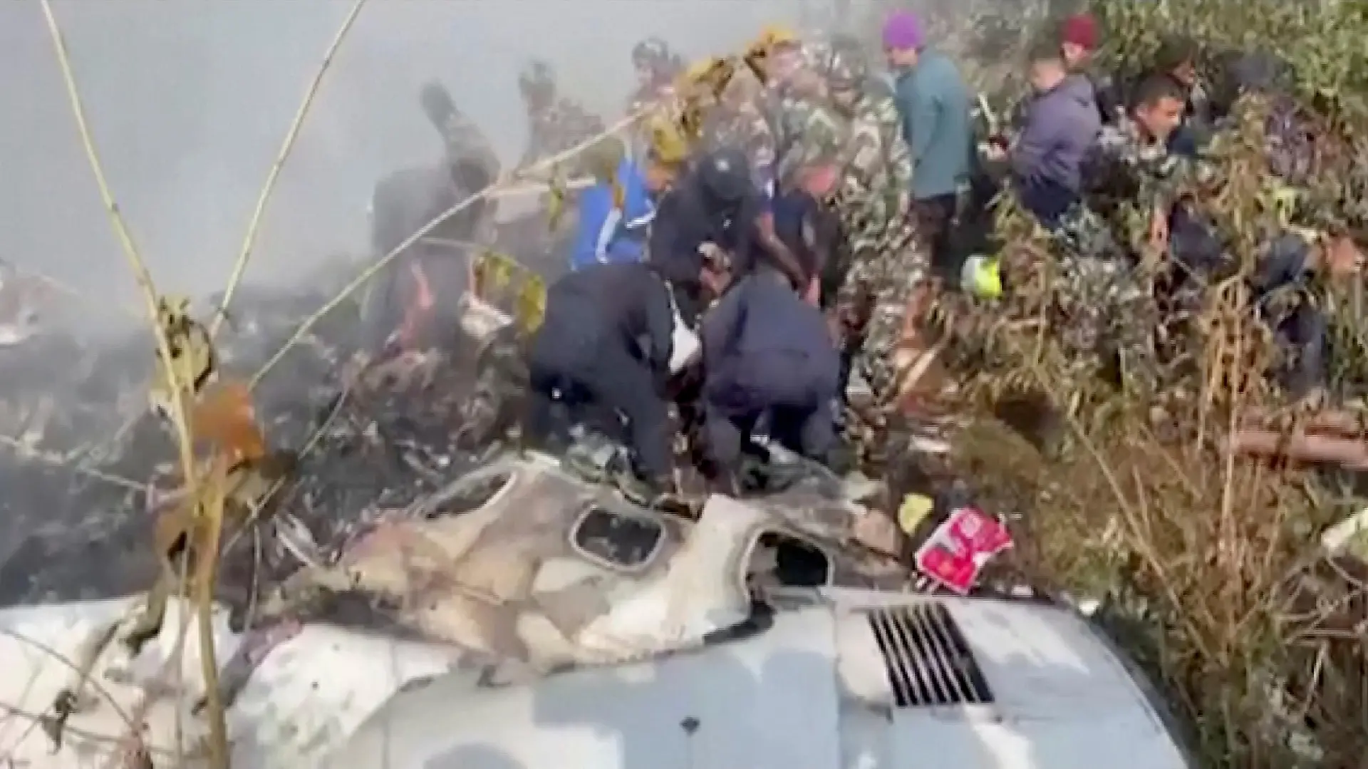 Rescuers work at the site of a plane crash in Pokhara, Nepal January 15, 2023, in this screen grab taken from a handout video. ANI/Handout/via REUTERS  ATTENTION EDITORS - THIS IMAGE HAS BEEN SUPPLIED BY A THIRD PARTY. INDIA OUT. NO COMMERCIAL OR EDITORIAL SALES IN INDIA