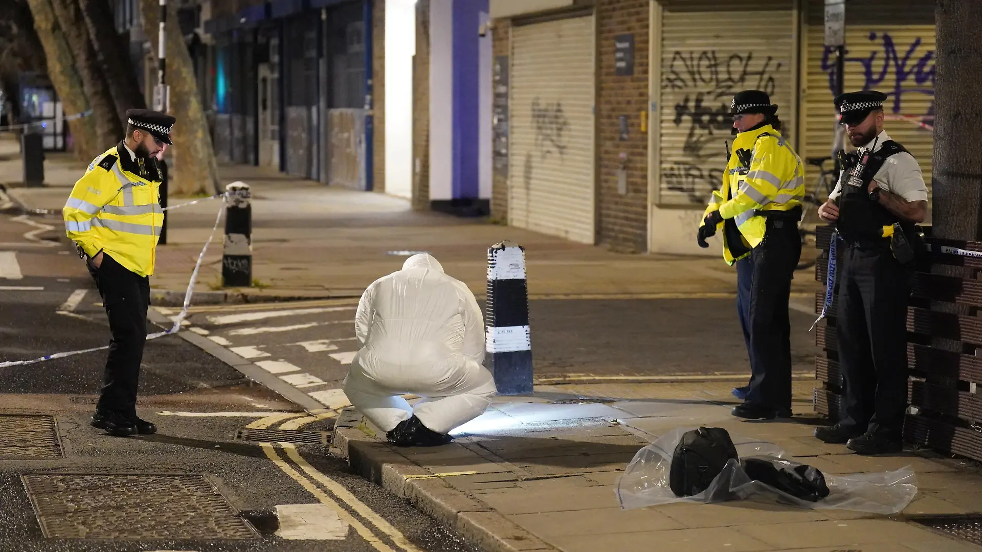 Drive-by shooting - Euston. A police forensics officer works near to the scene of a suspected drive-by shooting in Phoenix Road, next to Euston station in north London, where three women, aged 48, 54 and 41 along with a seven-year-old girl have been injured near a church where a funeral was taking place. Picture date: Saturday January 14, 2023. Their injuries have been assessed as non-life threatening, though the 48-year-old may have life-changing injuries. A seven-year-old girl was also taken to hospital and is believed to have been injured in the same incident. Officers said their initial inquiries suggest the shots came from a moving vehicle, which was then driven away from the scene. See PA story POLICE Funeral. Photo credit should read: James Manning/PA Wire URN:70564582
