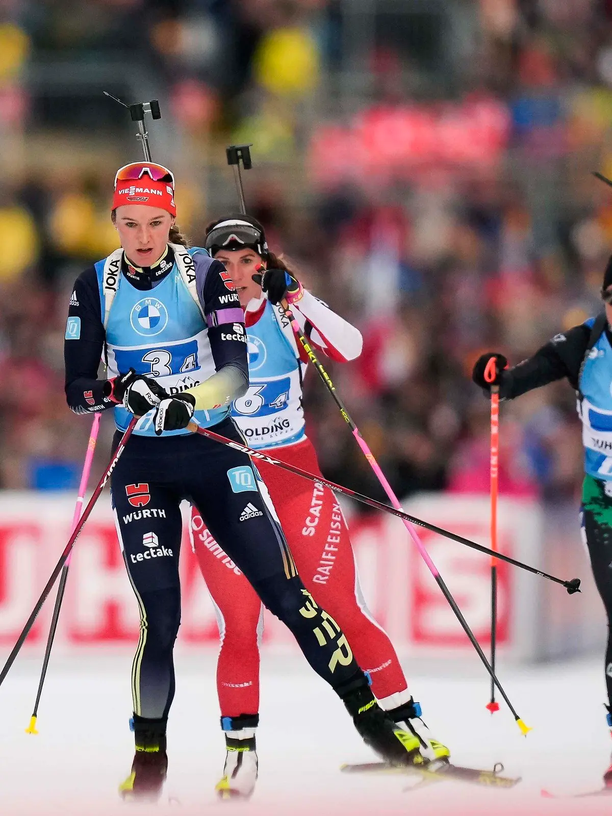 Denise Herrmann-Wick of Germany, from left, Lena Haecki-Gross of Switzerland and Dorothea Wierer of Italy arrive the shooting ranch during the women's 4x6km relay competition at the Biathlon World Cup race in Ruhpolding, Germany, Saturday, Jan. 14, 2023. (AP Photo/Matthias Schrader)