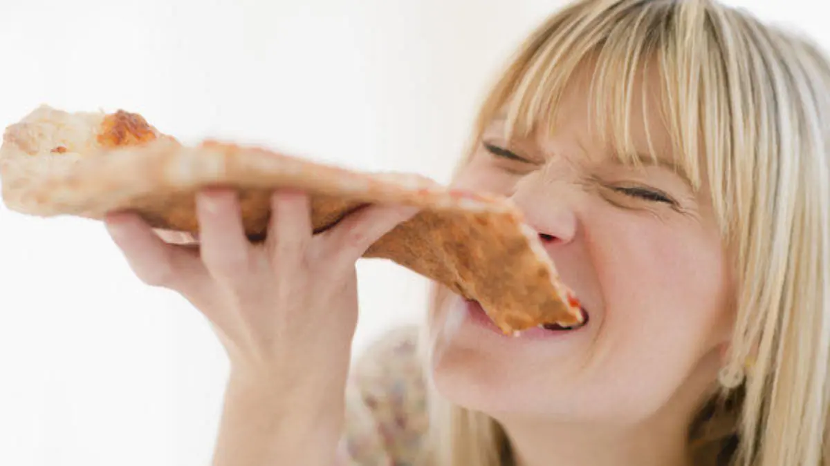 Young woman eating pizza Keine Weitergabe an Drittverwerter.