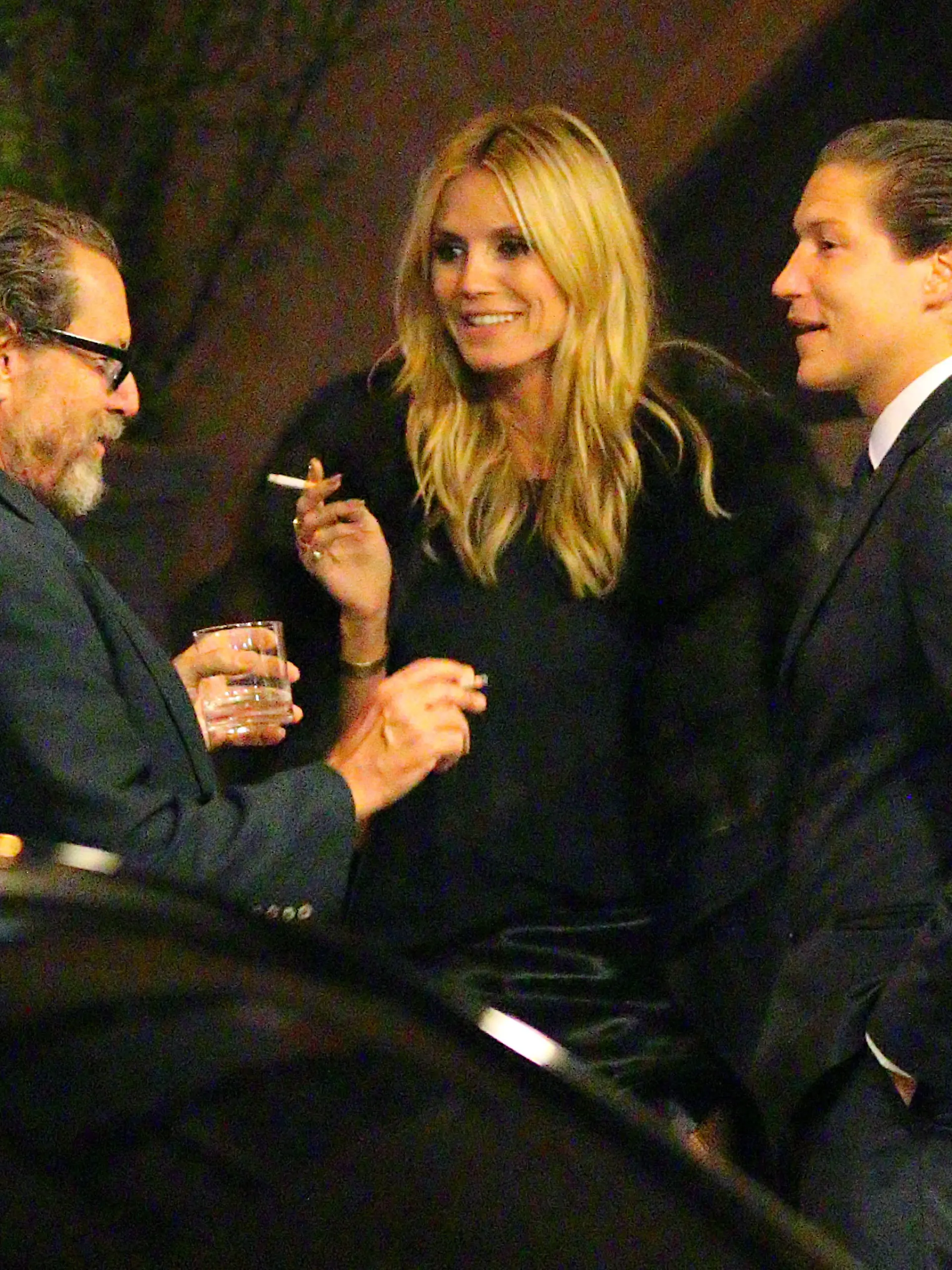 EXCLUSIVE: Things are getting serious! Heidi Klum licks her lips as she looks towards Vito Schnabel with a cigarette in hand, while Julian Schnabel looks on, during a break at the John Pizzarelli/Daniel Jobim performance at the Carlyle Hotel in NYC on April 17, 2015.