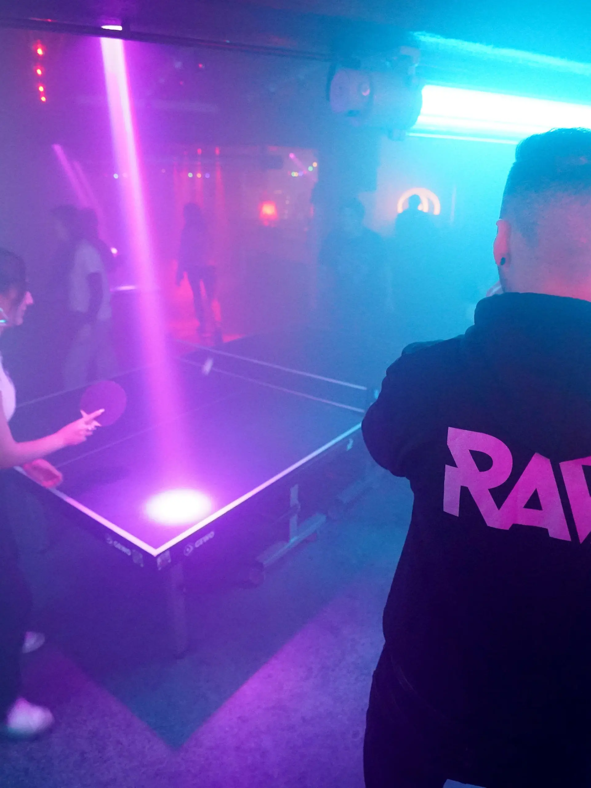 PRODUKTION - 05.01.2023, Hamburg: Clubbesucher spielen Tischtennis-Rundlauf zu wuchtigen Techno-Beats während der wöchentlichen Veranstaltung ·Topspin Techno· im Solar Club im Baalsaal auf der Reeperbahn. Techno, Tischtennis, Topspin - was als Idee für ein oder zwei Events startete, hat sich mittlerweile in der Hamburger Techno-Szene fast schon als Pflichttermin an Donnerstagen entwickelt. Wer Lust auf Tischtennis-Rundlauf und Sets von Hamburger DJs hat ist bei Topspin auf jeden Fall an der richtigen Adresse. (zu dpa ·Topspin Techno - Tischtennis im Szeneclub·) Foto: Marcus Brandt/dpa +++ dpa-Bildfunk +++