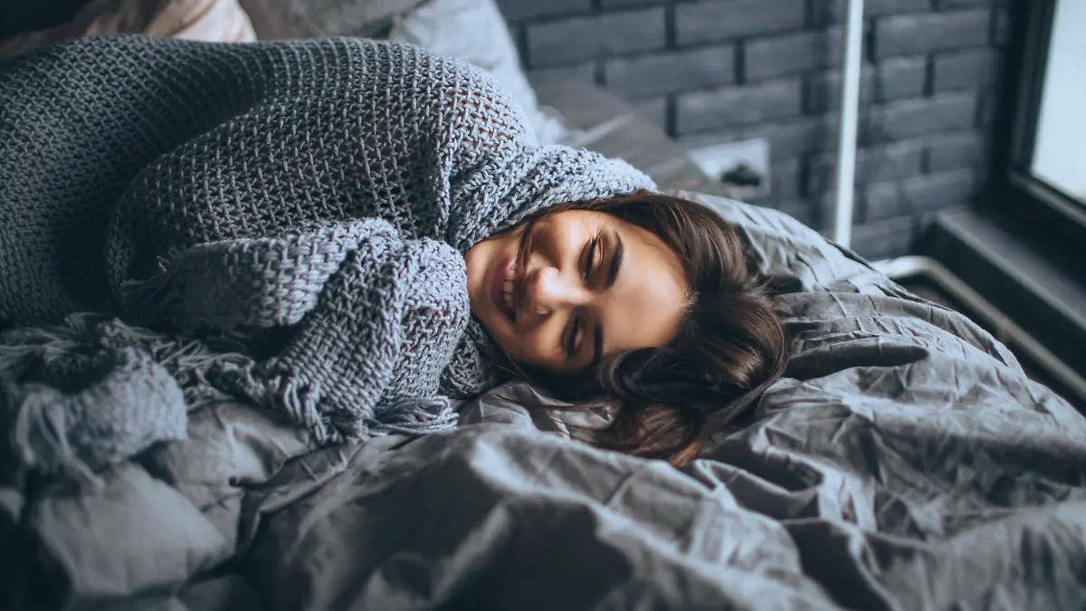 Young woman in a bedroom, waking up