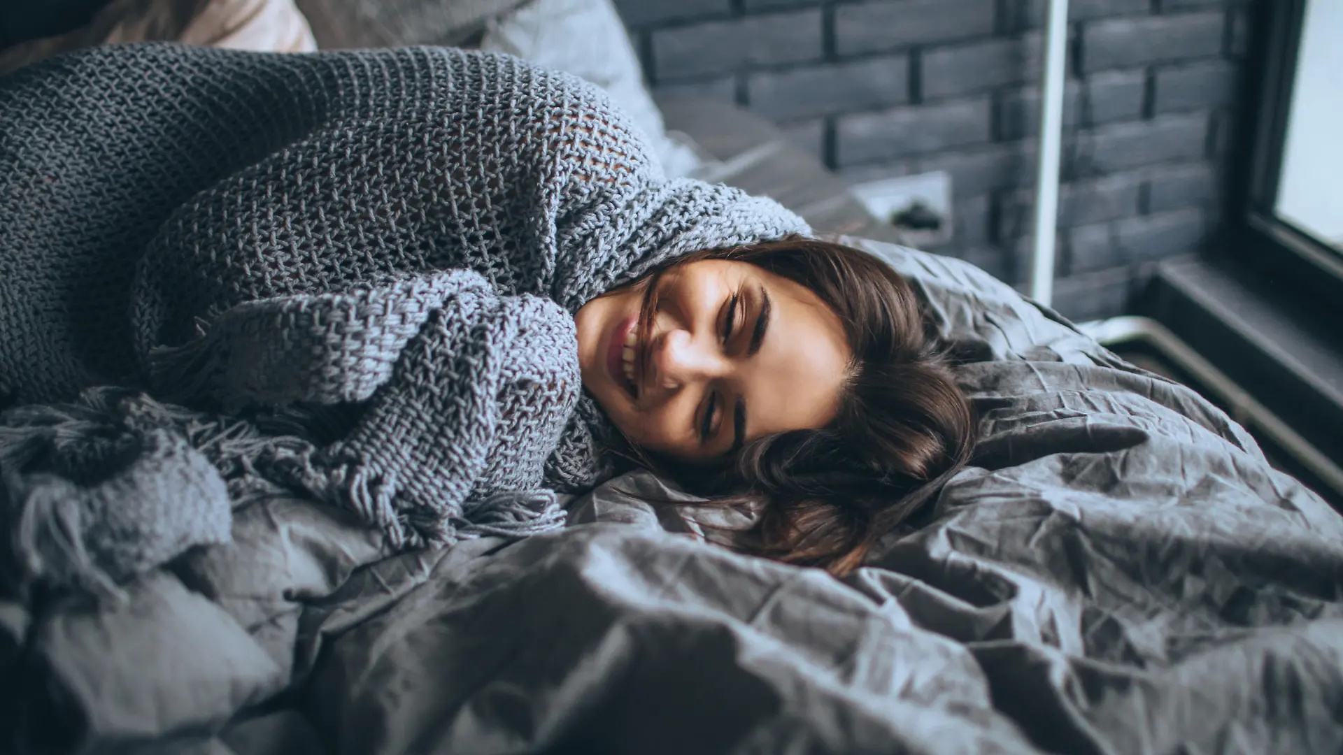 Young woman in a bedroom, waking up