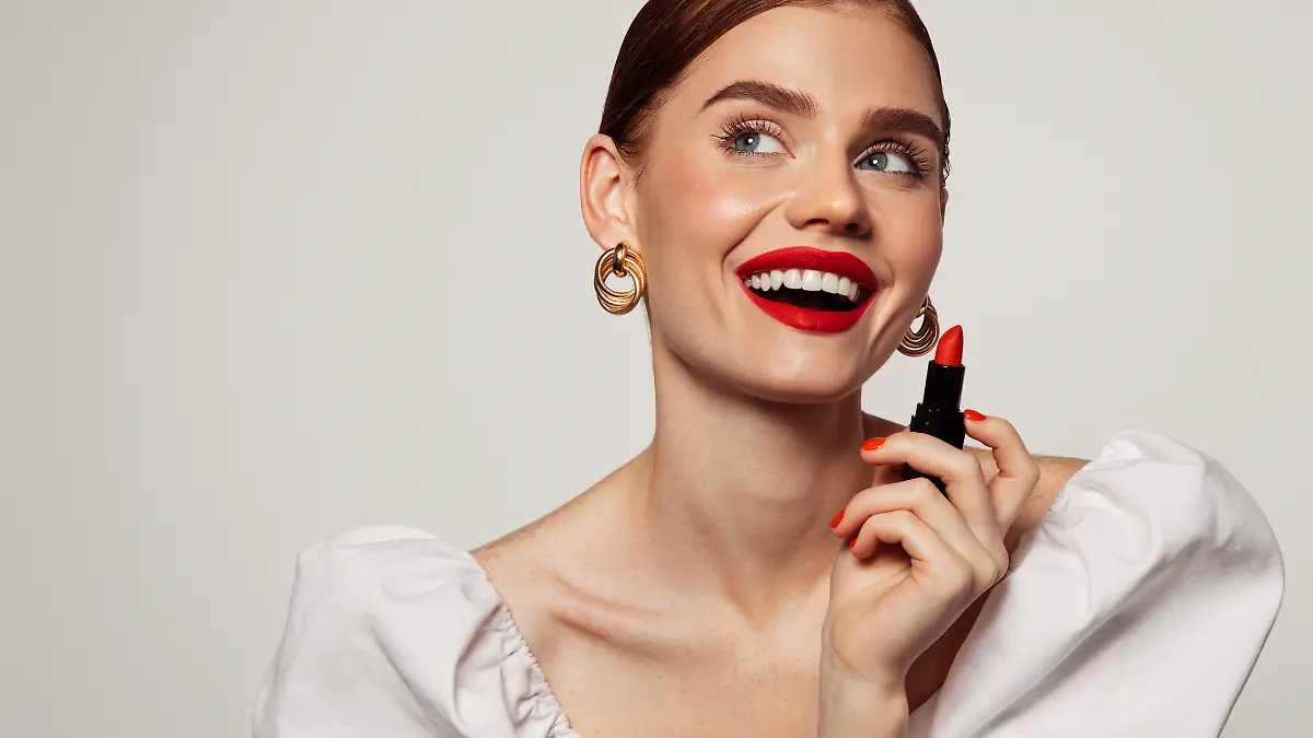 Frau ist geschminkt und trägt roten Lippenstift. 