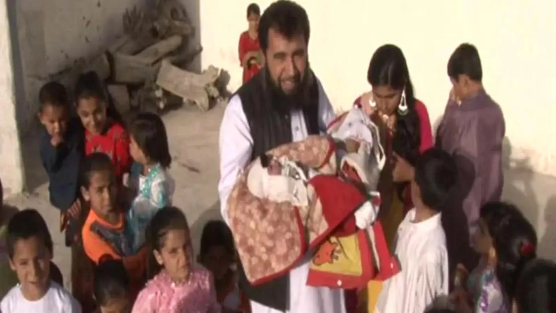 Story from Jam Press (60 Children)
Pictured: Sardar Jan Mohammad Khan Khilji with his new baby.
Dad, 50, with three wives welcomes 60th child – and says he wants more.
A dad has welcomed his 60th child into the world – and says he wants even more.
Sardar Jan Mohammad Khan Khilji's latest tot is called Haji Khushhal Khan.
The busy dad was snapped cradling his newborn son while surrounded by over a dozen of his other young children.
The dad from Quetta, Pakistan boasts a large brood thanks to the help of his three wives.
And he is now asking friends to help him find lucky wife number four.
It is not known when he first became a father or the ages of his other children.
Sardar, who works as a doctor, is said to be struggling to feed his family due to spiralling food costs.
Speaking to local media he said: "Business has come to a standstill.
"The prices of all basic things including flour, ghee and sugar have tripled.
"For the last three years, all Pakistanis, including the whole world, are facing difficulties, including me."
The doctor is also said to have pleaded with the Pakistani government to provide him with a bus for family outings.
ENDS