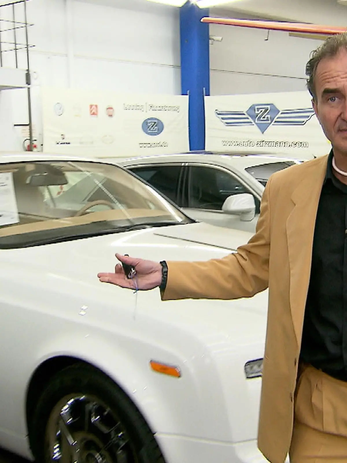 Christoph Zitzmann in seinem Laden mit Luxusautos.