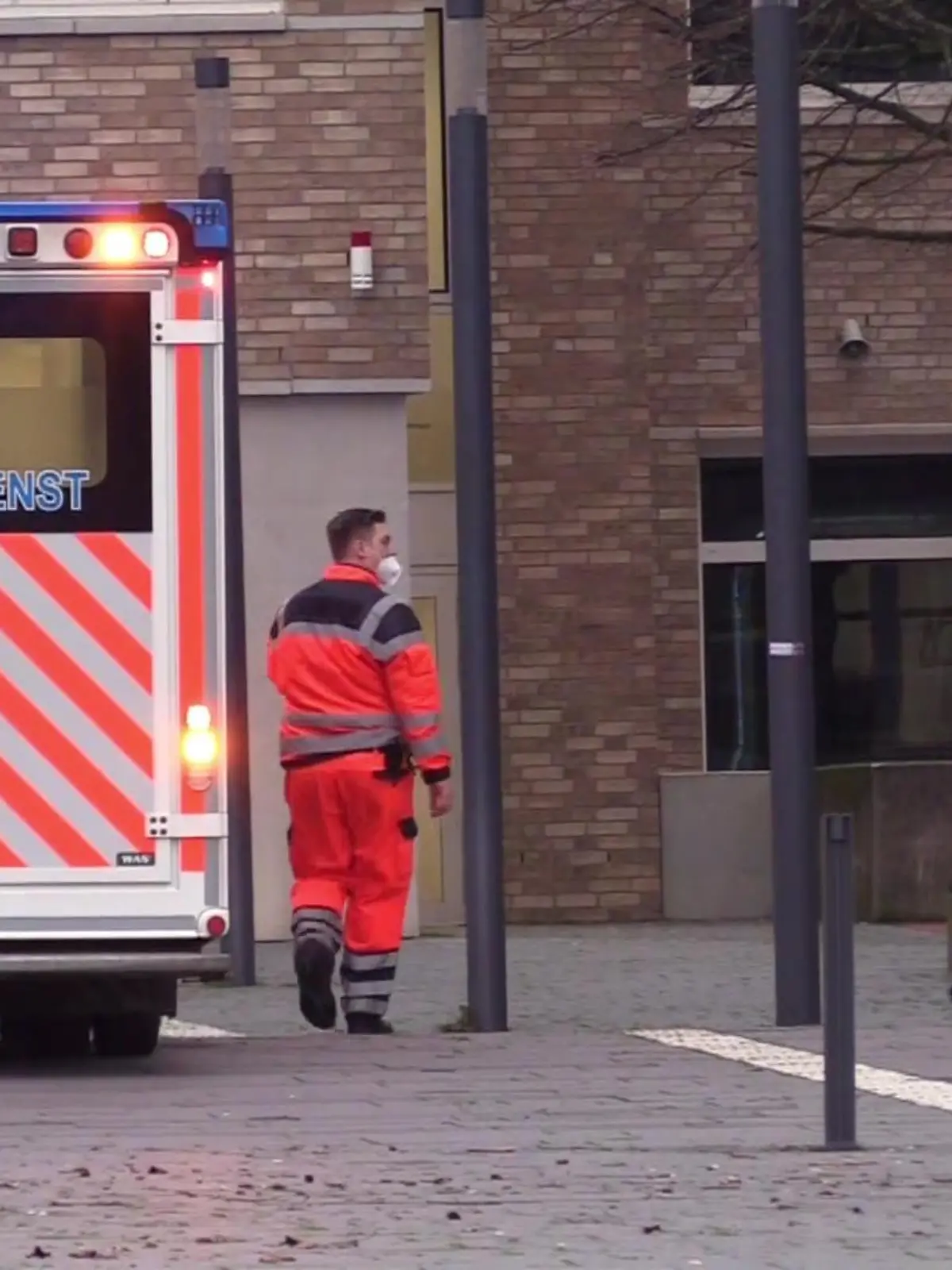 10.01.2023, Nordrhein-Westfalen, Ibbenbüren: Ein Rettungswagen steht in Ibbenbüren. Ein 17-jähriger Schüler soll im münsterländischen Ibbenbüren seine Lehrerin umgebracht haben. Der Jugendliche habe nach der Tat selbst den Notruf gewählt und sich widerstandslos festnehmen lassen, sagte ein Sprecher der Staatsanwaltschaft in Münster am Dienstagabend. Die Tat habe sich an einem Berufskolleg ereignet. Foto: -/NWM-TV/dpa +++ dpa-Bildfunk +++
