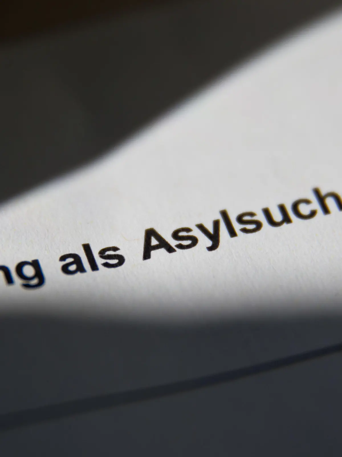 ARCHIV - 17.07.2014, Bayern, Zirndorf: «Meldung als Asylsuchender» ist in der Zentralen Aufnahmeeinrichtung für Asylbewerber (ZAE) auf einer Meldebescheinigung für Asylsuchende zu lesen. (zu dpa "Mehr als 217 000 Menschen haben in Deutschland 2022 Asyl beantragt") Foto: Daniel Karmann/dpa +++ dpa-Bildfunk +++