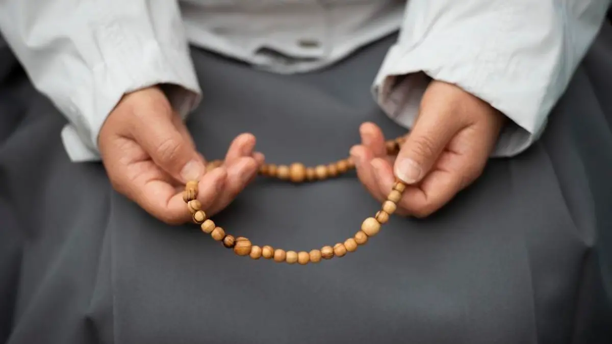 A nun praying the holy rosary, Vatican city.