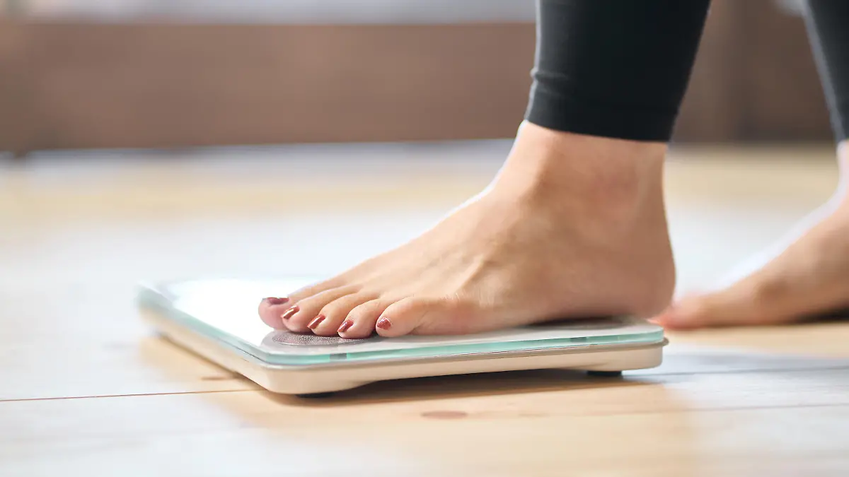 Feet of an Asian woman on a weight scale