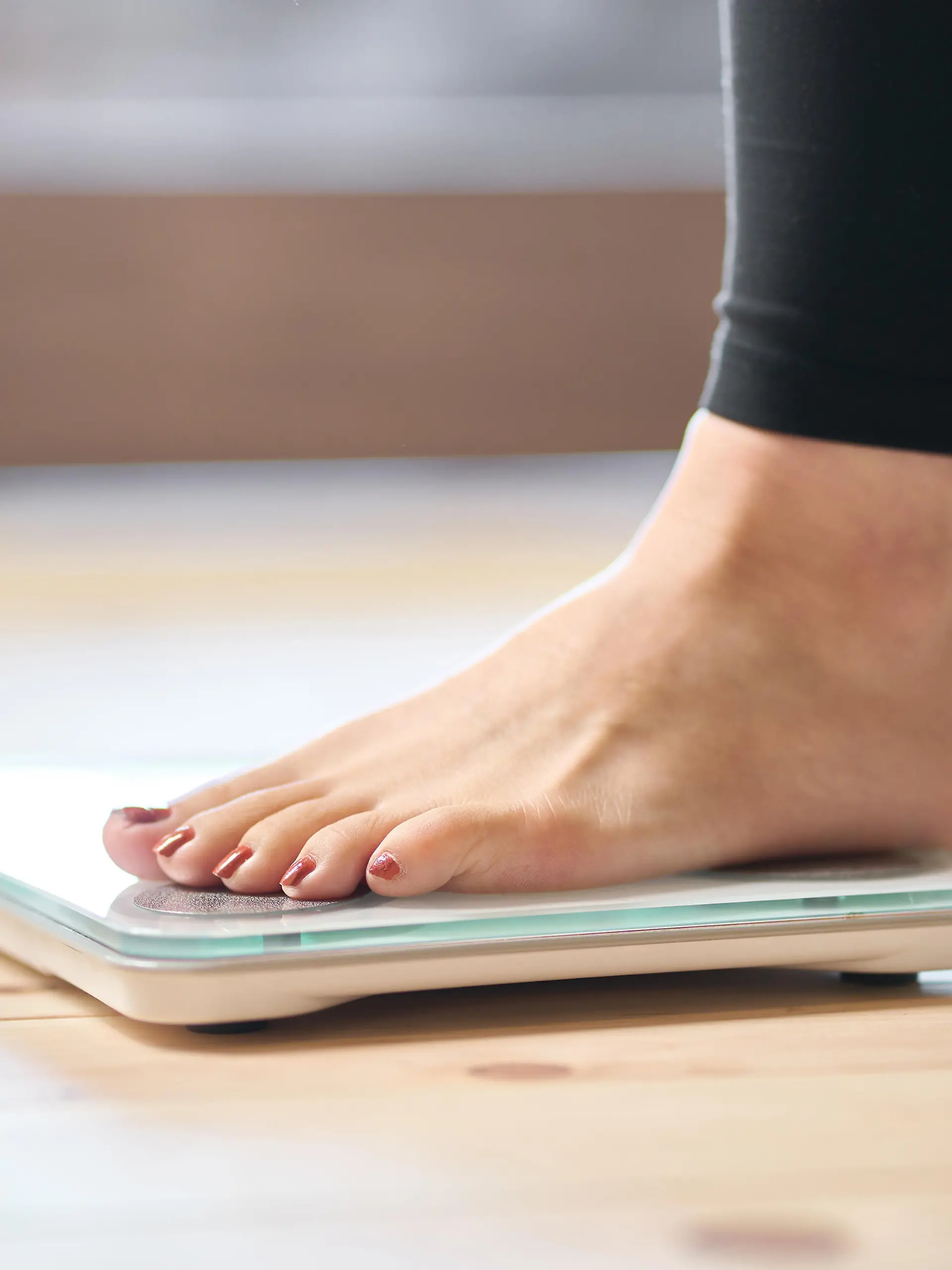 Feet of an Asian woman on a weight scale