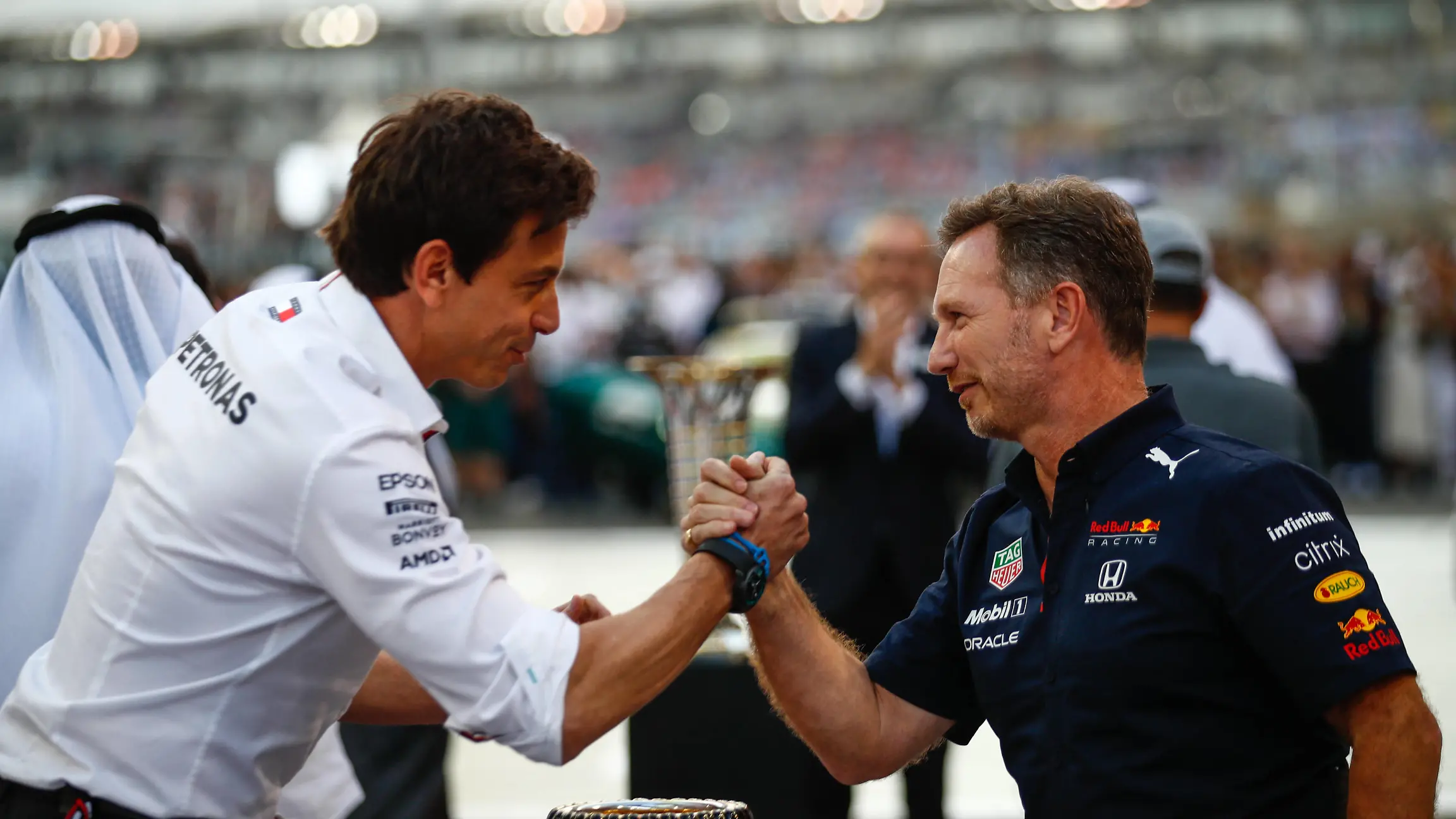 Formula 1 2021: Abu Dhabi GP YAS MARINA CIRCUIT, UNITED ARAB EMIRATES - DECEMBER 12: Toto Wolff, Team Principal and CEO, Mercedes AMG, and Christian Horner, Team Principal, Red Bull Racing, arm wrestle over the trophy on the grid during the Abu Dhabi GP at Yas Marina Circuit on Sunday December 12, 2021 in Abu Dhabi, United Arab Emirates. Photo by Sam Bloxham / LAT Images Images PUBLICATIONxINxGERxSUIxAUTxHUNxONLY GP2122_134506_J6I1754