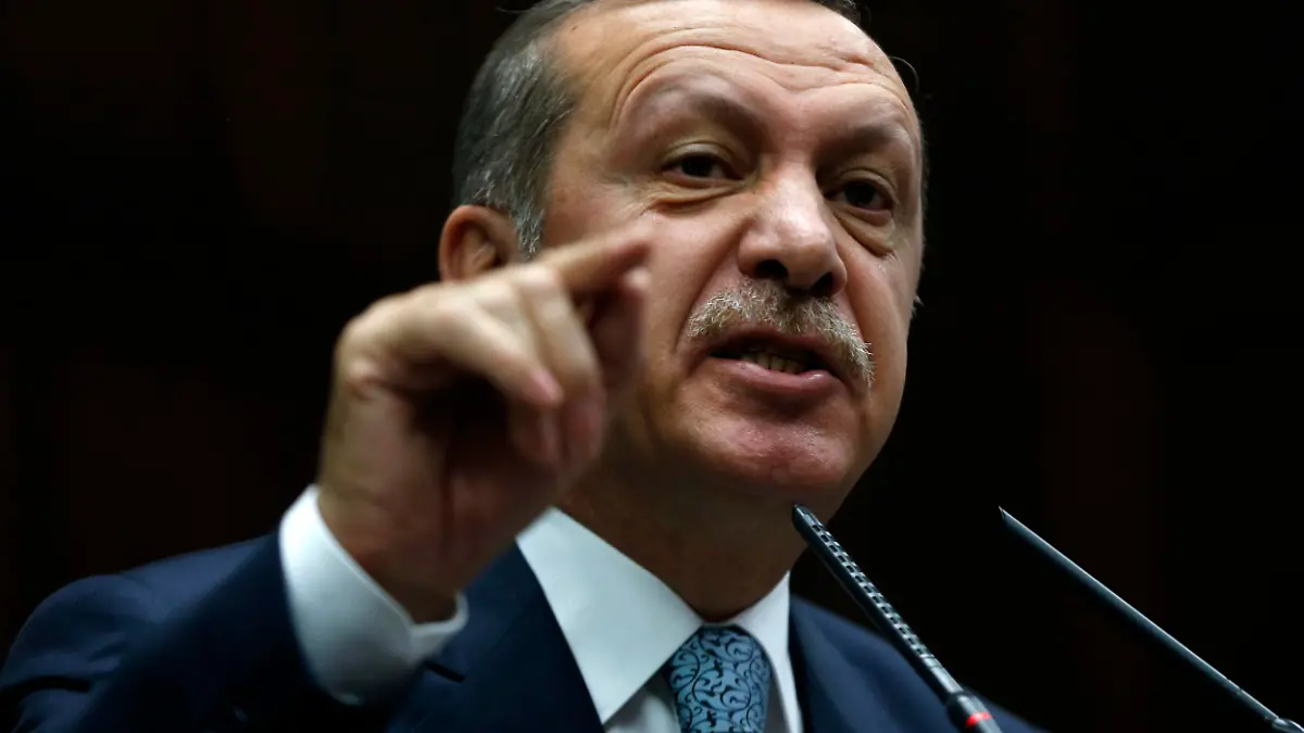 Turkey's Prime Minister Tayyip Erdogan addresses members of parliament from his ruling AK Party (AKP) during a meeting at the Turkish parliament in Ankara February 25, 2014. Erdogan said on Tuesday voice recordings purportedly of him telling his son to dispose of large sums of money on the day news broke of a graft inquiry were a "treacherous attack" on his office. REUTERS/Umit Bektas (TURKEY - Tags: POLITICS BUSINESS)