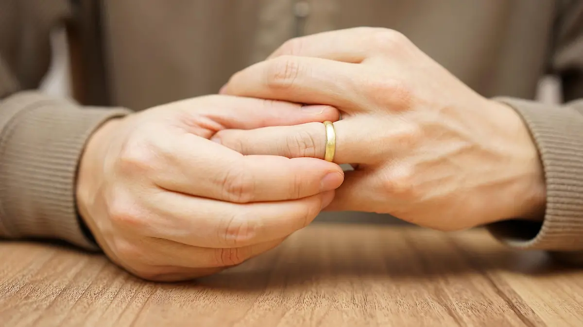 Man is taking off the wedding ring