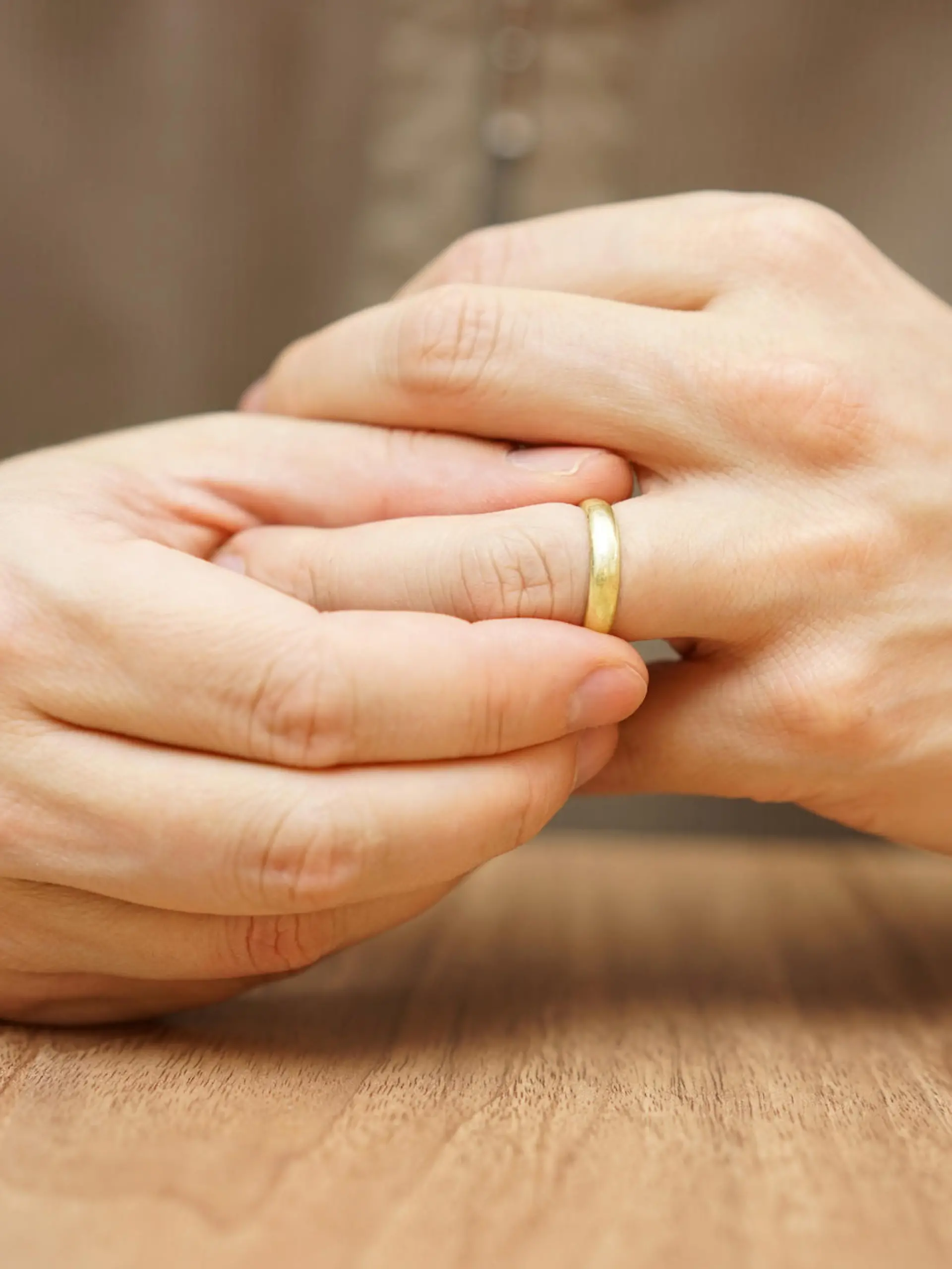 Man is taking off the wedding ring