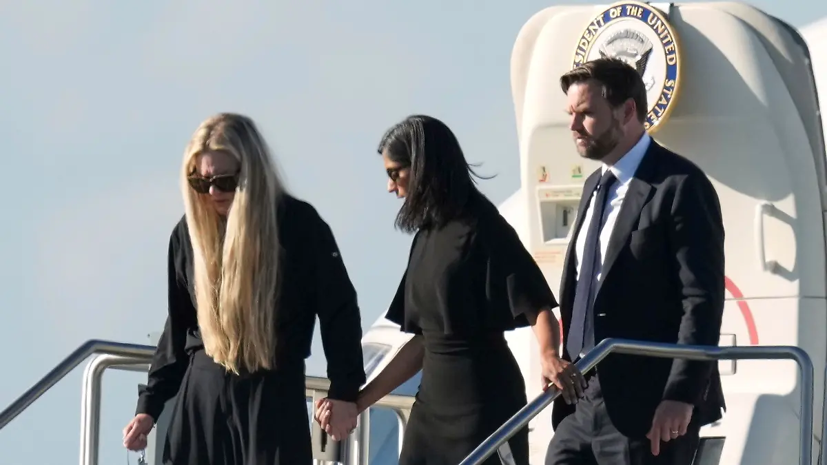 Vice President JD Vance, right, Second Lady Usha Vance, center, and Erika Kirk, holding a cross on a chain, deplane Air Force Two, carrying the body of Charlie Kirk, the CEO and co-founder of Turning Point USA who was shot and killed, Thursday, Sept. 11, 2025, in Phoenix. (AP Photo/Ross D. Franklin)