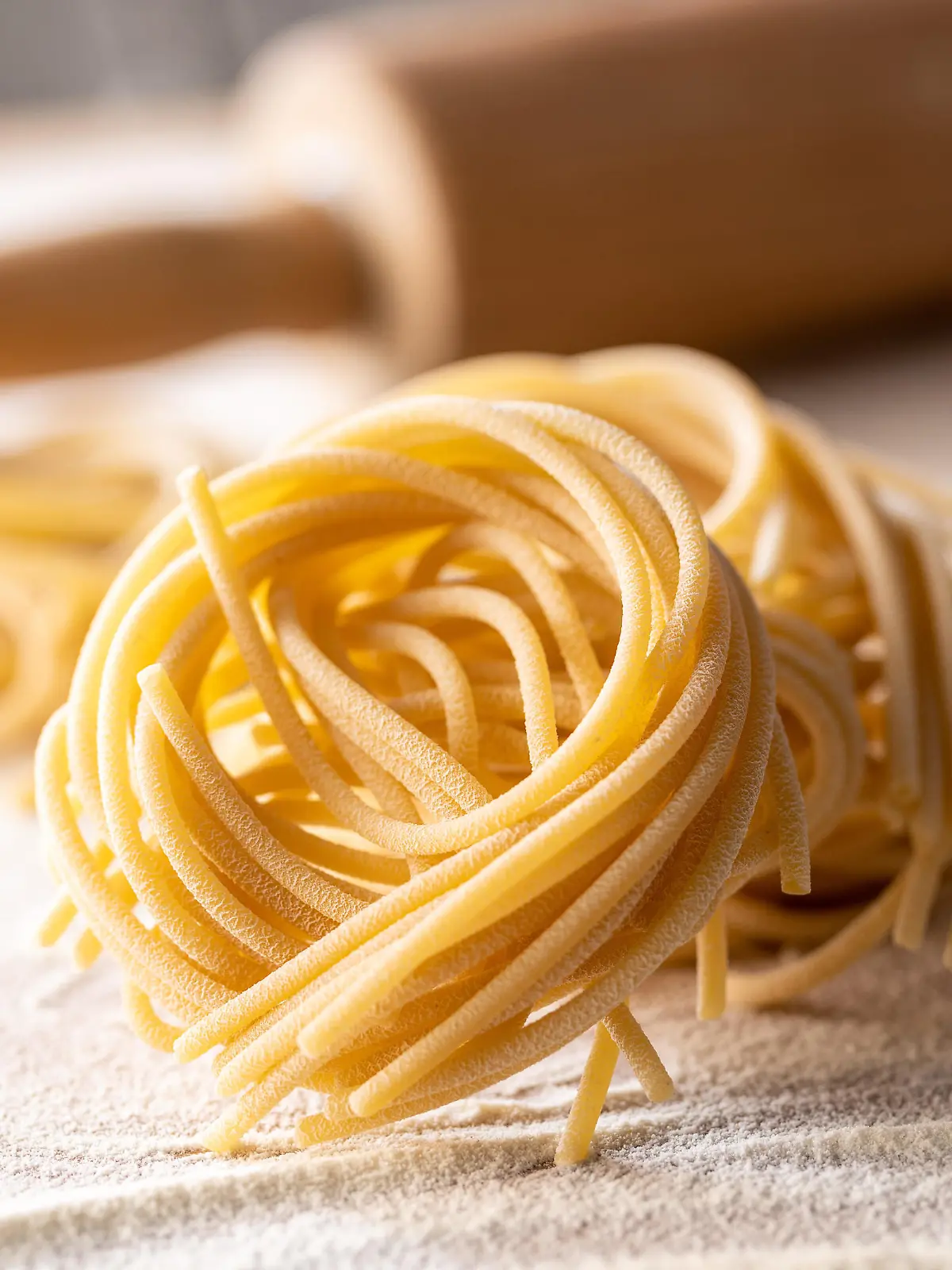 Italian pasta nest. Uncooked spaghetti nest and flour.