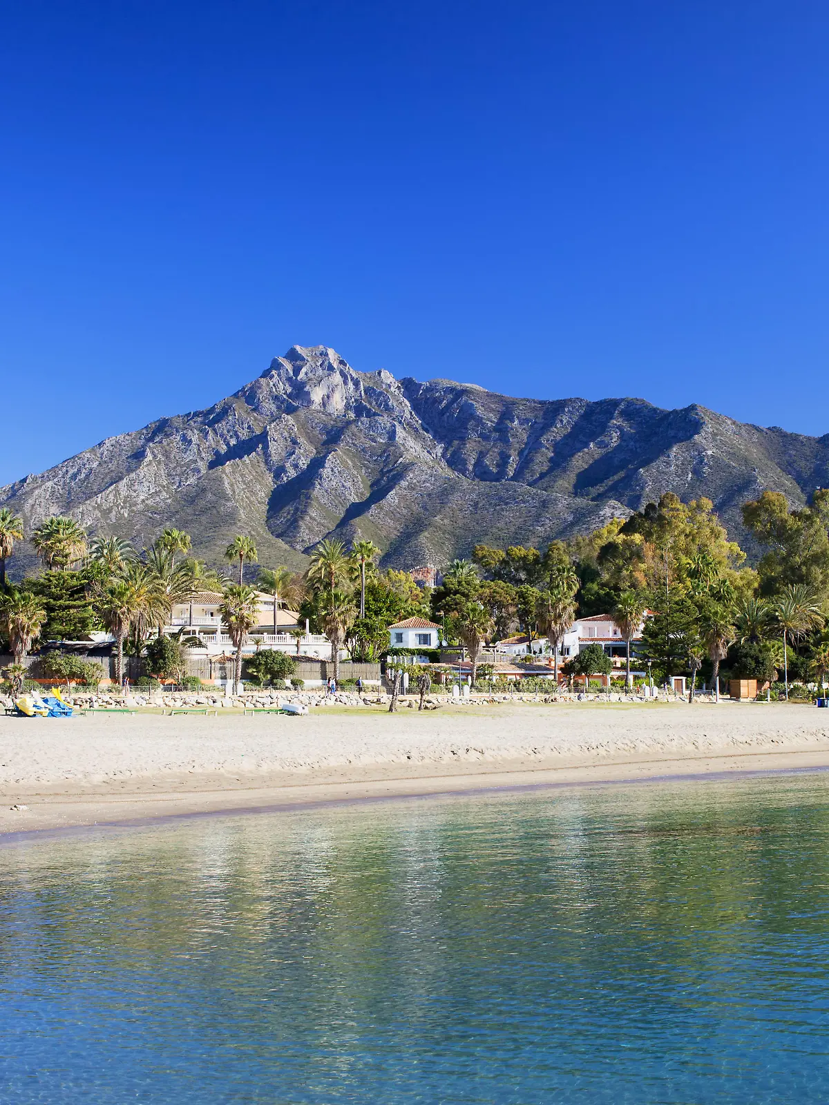 Marbella sandy beach, summer holiday scenery by the Mediterranean Sea in Spain, Andalusia region, Costa del Sol, Malaga province.