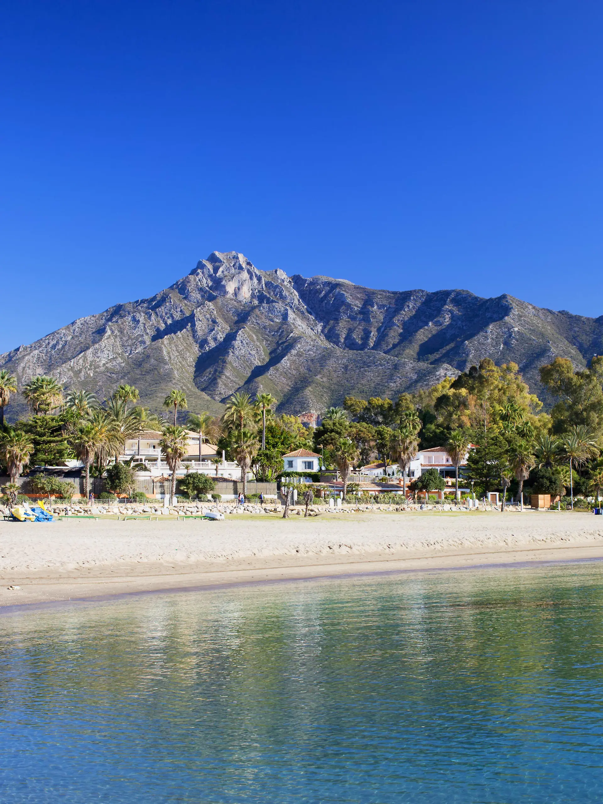Marbella sandy beach, summer holiday scenery by the Mediterranean Sea in Spain, Andalusia region, Costa del Sol, Malaga province.
