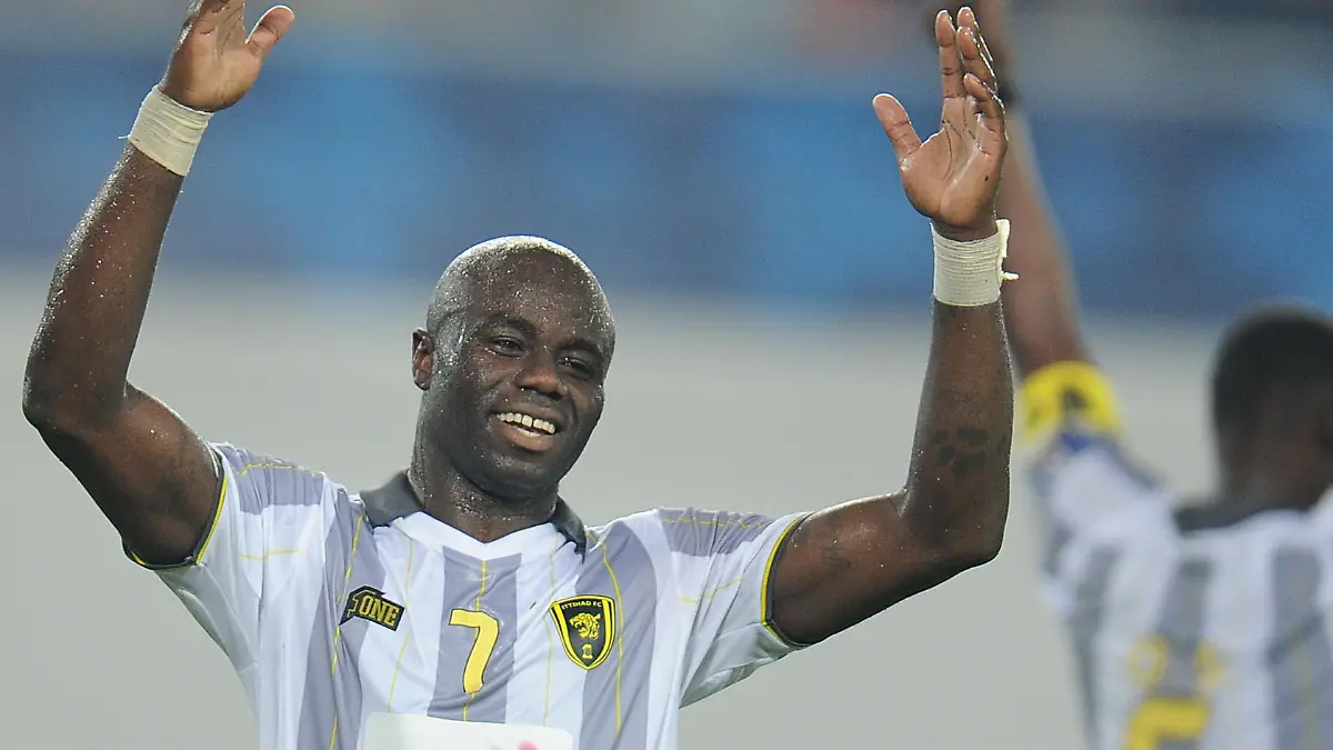 Al Ittihad's Modeste M'Bami (L) and Osama Al-Muwallad (R) celebrate as Guangzhou Evergrande's Feng Xiaoting (C) reacts after a match at the AFC Champions League in Guangzhou in south China's Guangdong province on Tuesday, Oct. 2, 2012. A late Al Ittihad goal made it 1-2 in the match and 5-4 on aggregate. It sent Marcello Lippi's Guangzhou Evergrande crashing out of the AFC Champions League.(Photo By Fang Yingzhong/Color China Photo/AP Images)