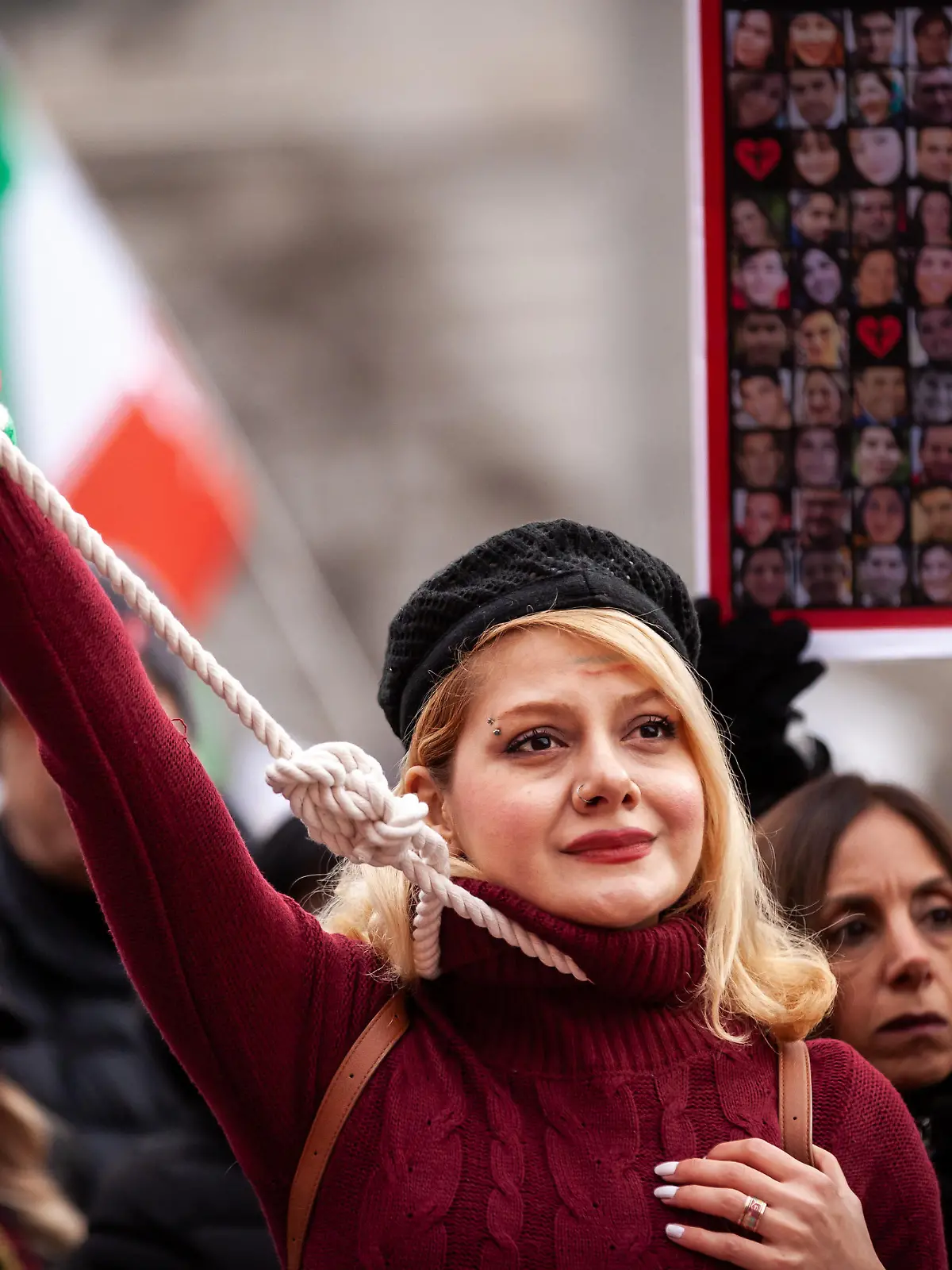 A woman wears a noose and ribbons to protest teh execution of Mohsen Shekari by the Islamic regime in Iran at a protest on International Human RIghts Day. Demonstrators demanded justice for Shekari, a 23-year-old man executed December 8 for allegedly blocking a street and injuring a soldier during a protest. (Photo by Allison Bailey/NurPhoto)