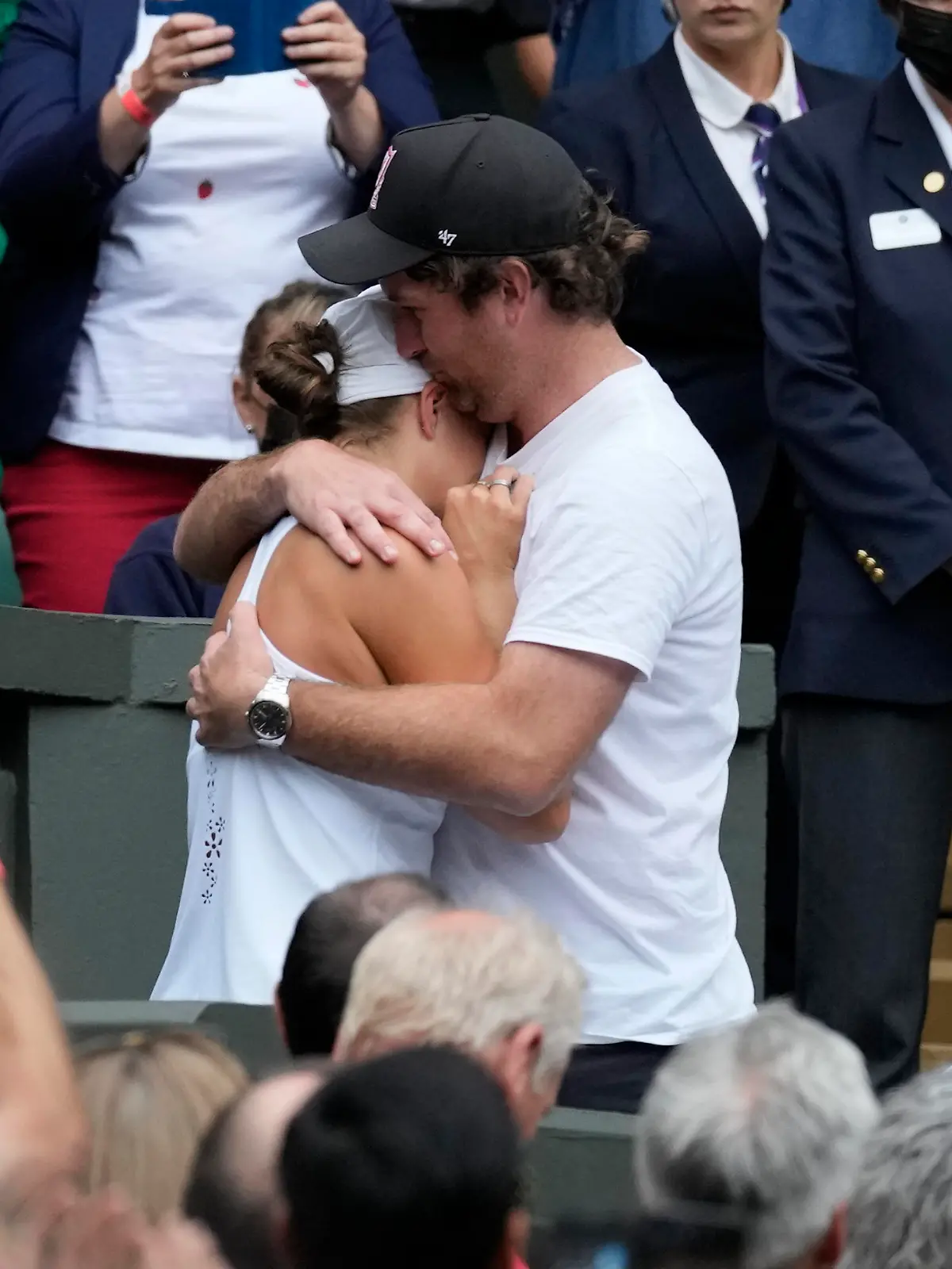 Australia's Ashleigh Barty hugs her boyfriend Gary Kissick in the players box as she celebrates after defeating reacts after defeating the Czech Republic's Karolina Pliskova in the women's singles final on day twelve of the Wimbledon Tennis Championships in London, Saturday, July 10, 2021. (Pete Nichols/Pool Via AP)