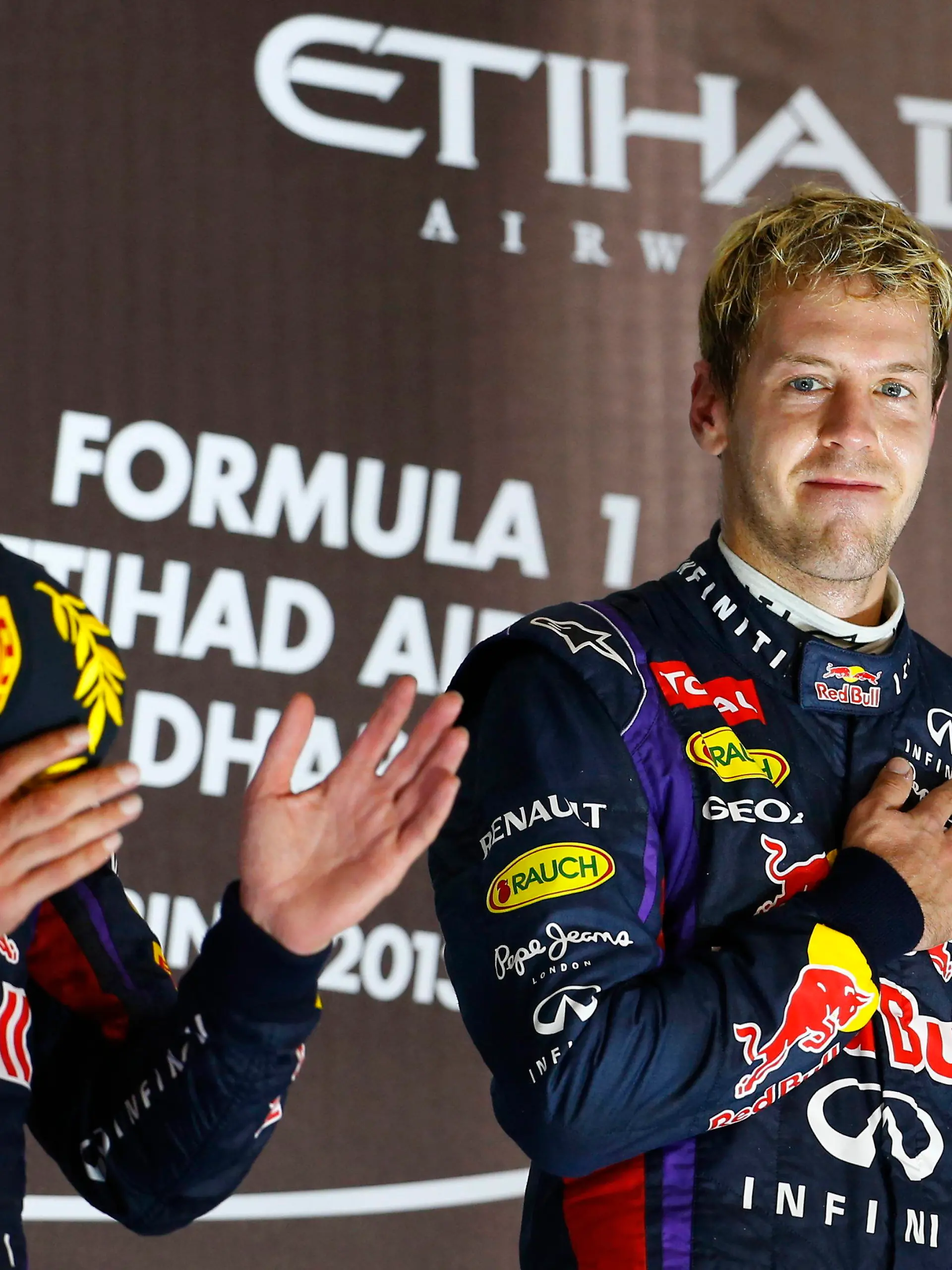 epa03934700 German Formula One driver Sebastian Vettel of Red Bull Racing celebrates on the podium with his teammate Australian Mark Webber (L) after winning the Formula One Grand Prix of Abu Dhabi at the Yas Marina Circuit in Abu Dhabi, United Arab Emirates, 03 November 2013. EPA/VALDRIN XHEMAJ +++(c) dpa - Bildfunk+++