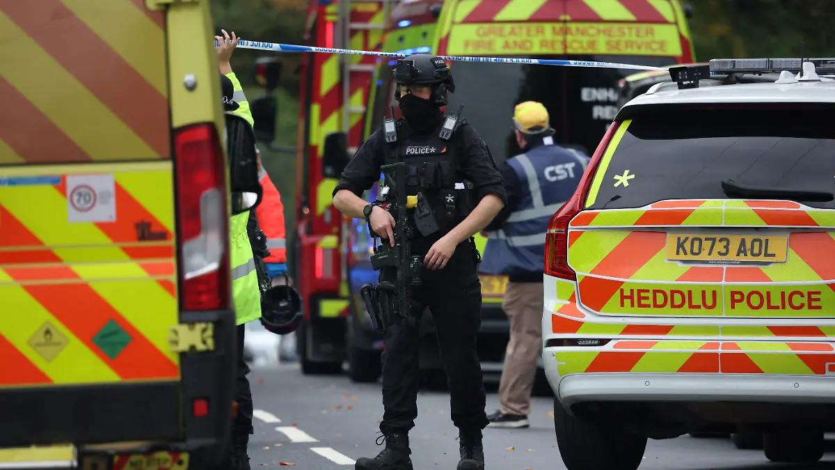 Emergency personnel work at the scene following an incident outside a synagogue, in Manchester