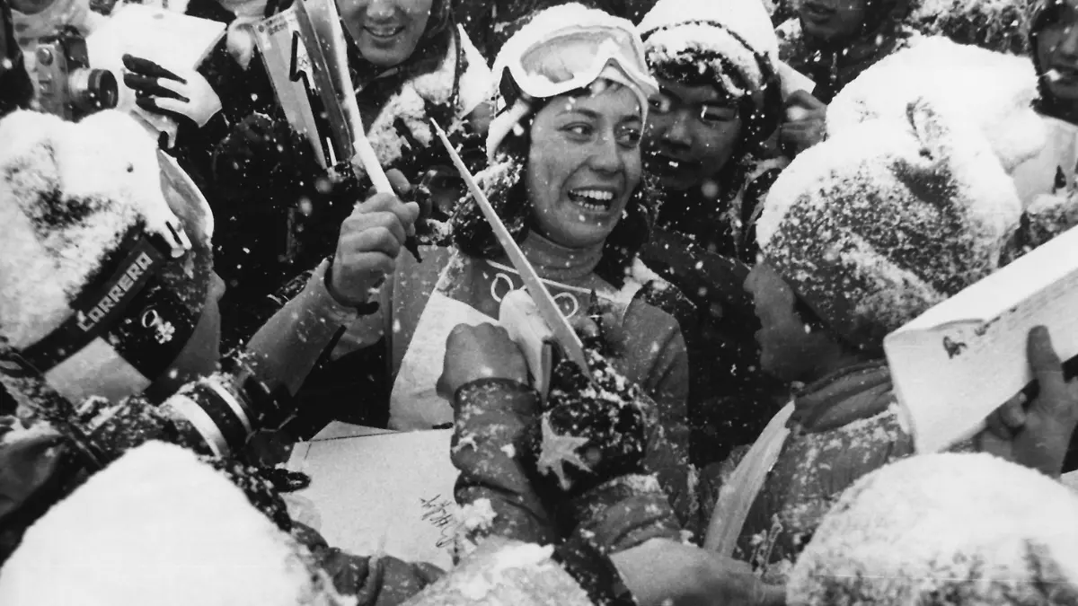 ARCHIV - 08.02.1972, Japan, Sapporo: Rosi Mittermaier schreibt lachend Autogramme für japanische Zuschauer. Die deutsche Ski-Ikone ist tot. Die frühere Skirennfahrerin starb am Mittwoch «nach schwerer Krankheit» im Alter von 72 Jahren, wie ihre Familie am Donnerstag mitteilte. Foto: Bendrihem/epa/dpa +++ dpa-Bildfunk +++