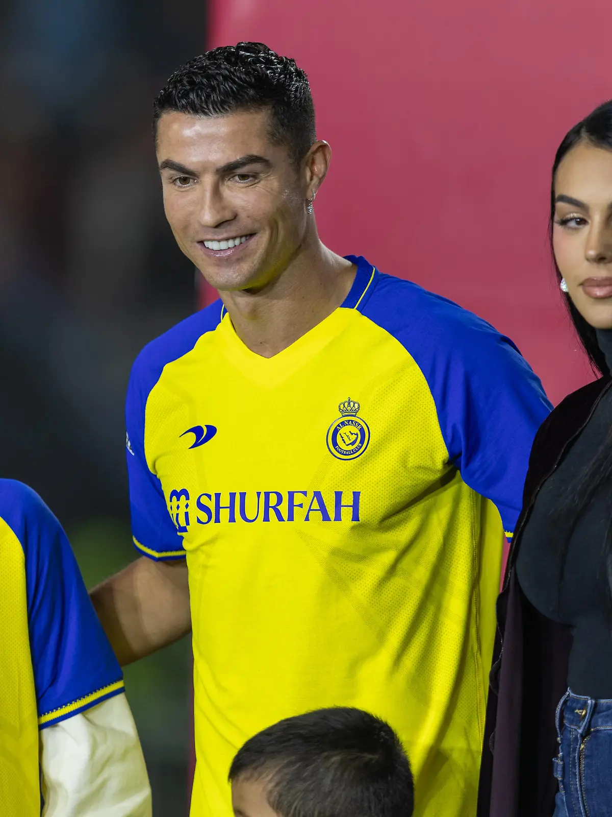 RIYADH, SAUDI ARABIA - JANUARY 03: Cristiano Ronaldo accompanied by his partner Georgina Rodriguez and his son Cristiano Ronaldo Jr, greet the crowd during the official unveiling of Cristiano Ronaldo as an Al Nassr player at Mrsool Park Stadium on January 3, 2023 in Riyadh, Saudi Arabia. (Photo by Yasser Bakhsh/Getty Images)