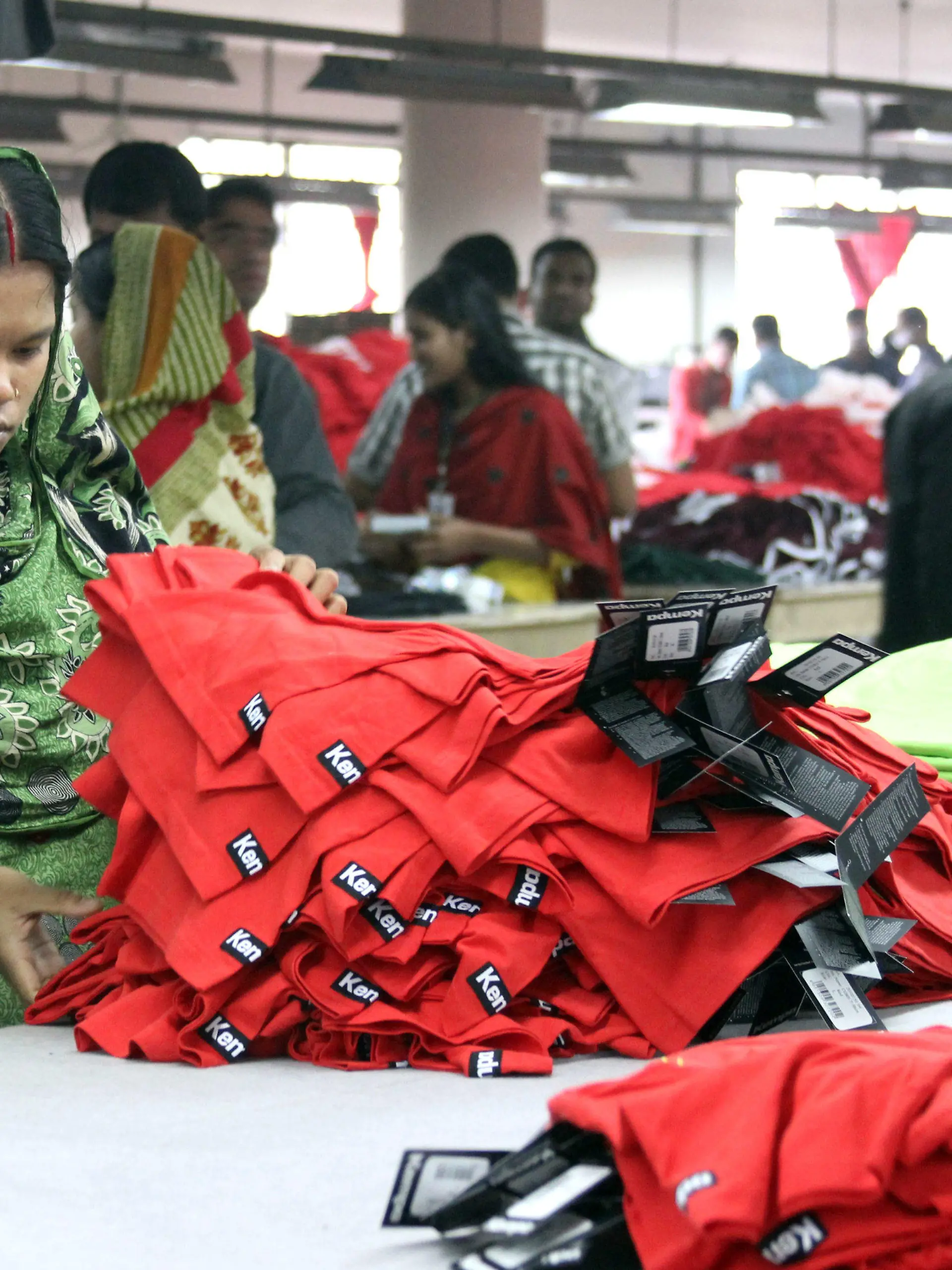 ARCHIV - Frauen und Männer arbeiten am 03.01.2014 in der Textilfabrik "One Composite Mills" in Gazipur, einem Vorort der Hauptstadt Dhaka in Bangladesch. Foto: Doreen Fiedler/dpa   (zu dpa "Umfrage: Verbraucher wollen bei Kleidung fair und billig zugleich" vom 12.08.2014) +++(c) dpa - Bildfunk+++