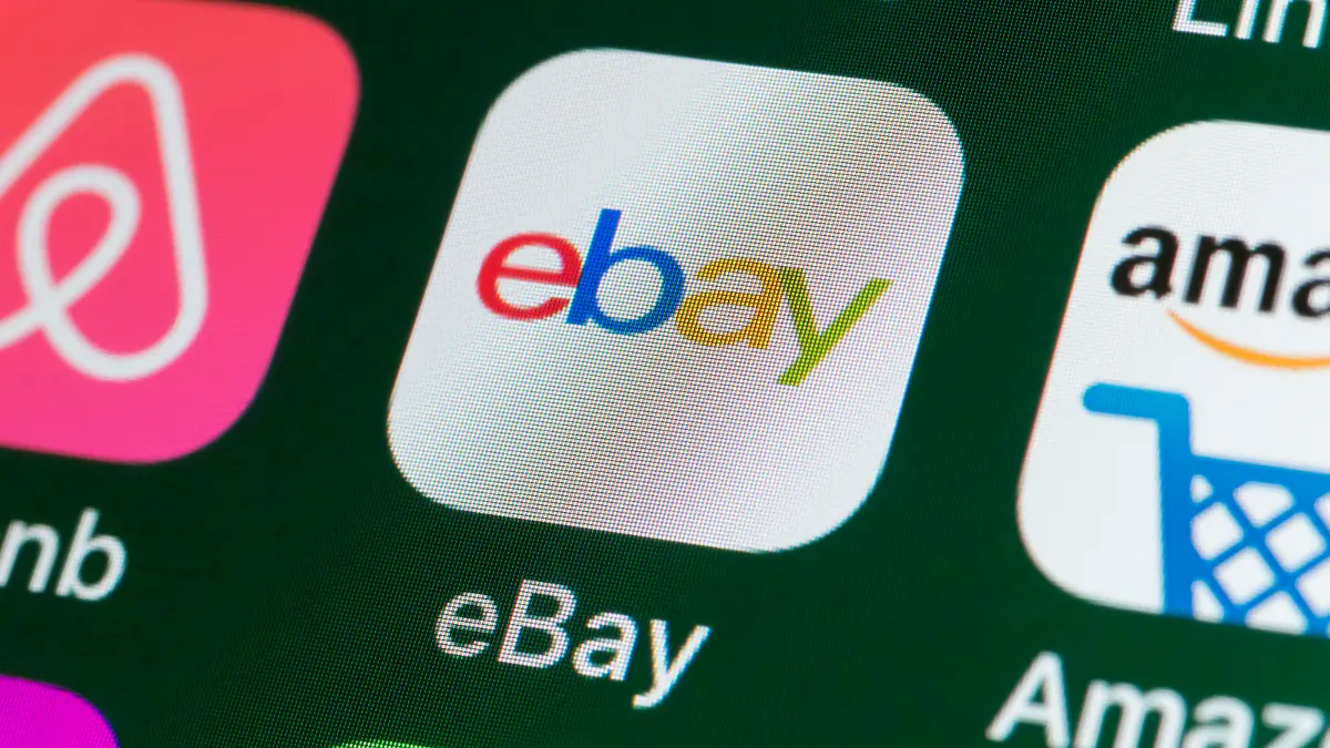 London, UK - July 31, 2018: The buttons of the online shopping app ebay, surrounded by Airbnb, Amazon, News and other apps on the screen of an iPhone.