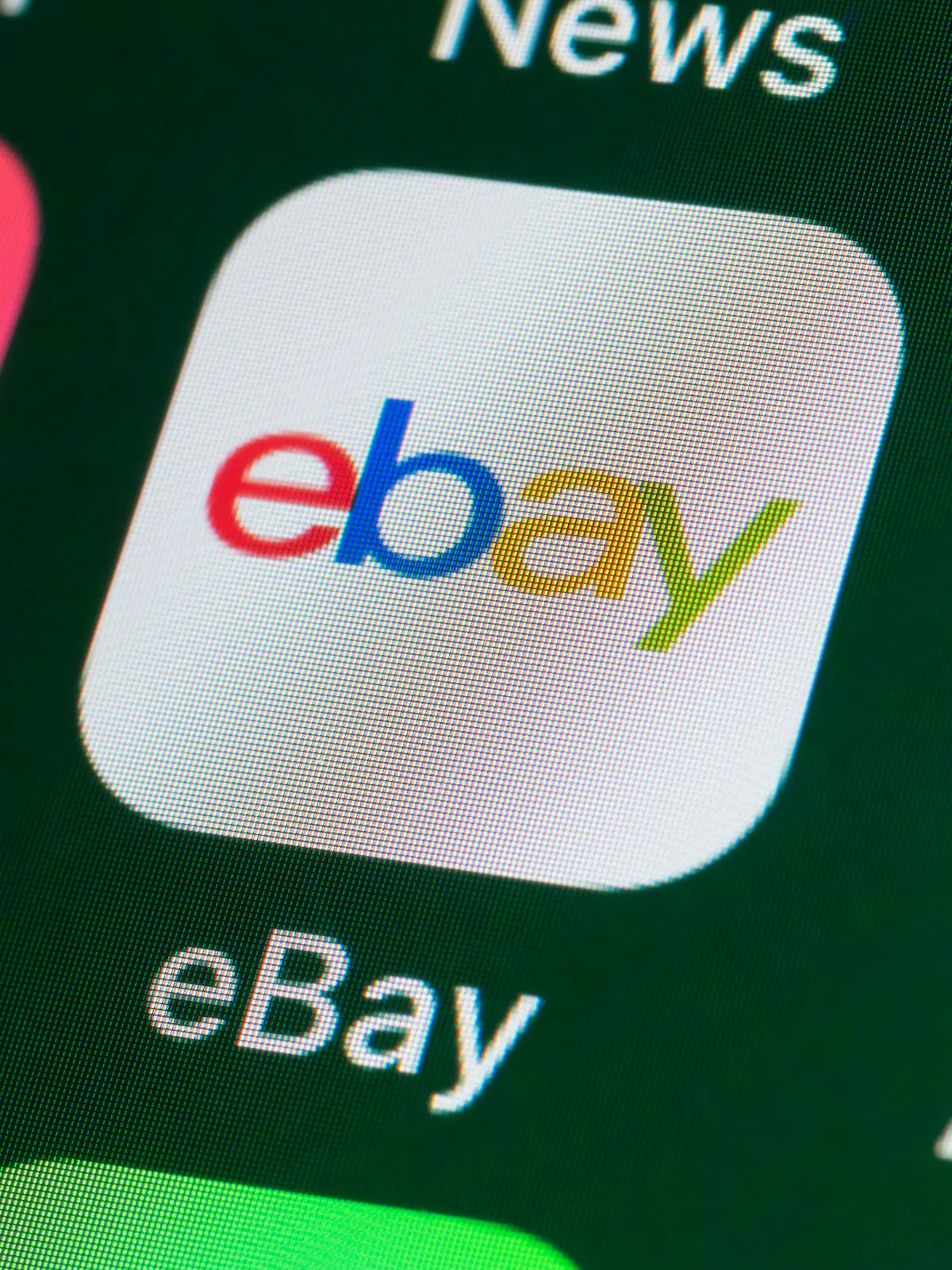 London, UK - July 31, 2018: The buttons of the online shopping app ebay, surrounded by Airbnb, Amazon, News and other apps on the screen of an iPhone.