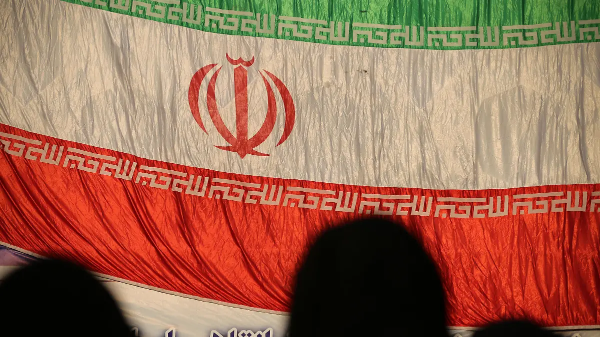 December 29, 2022, Tehran, Tehran, Iran: Three veiled women stand in front of the Iranian flag during the Dey 9 anniversary rally at Imam Hossein Square in downtown Tehran, Iran, on December 29, 2022. On 30 December 2009, pro-government rallies, also known as the Dey 9 epic, took place in various Iranian cities, including Tehran, Shiraz, Arak, Qom and Isfahan. The rallies were hold in response to the Ashura protests, where protesters on that day did acts including applauding, whistling, and engaging in other cheerful displays, which was viewed as violation of a red line and targeting Husayn ibn Ali and Ashura commemoration itself. The demonstrations and counter-demonstrations were connected to the disputed 2009 Iranian presidential election. (Credit Image: © Rouzbeh Fouladi via ZUMA Press Wire) / action press