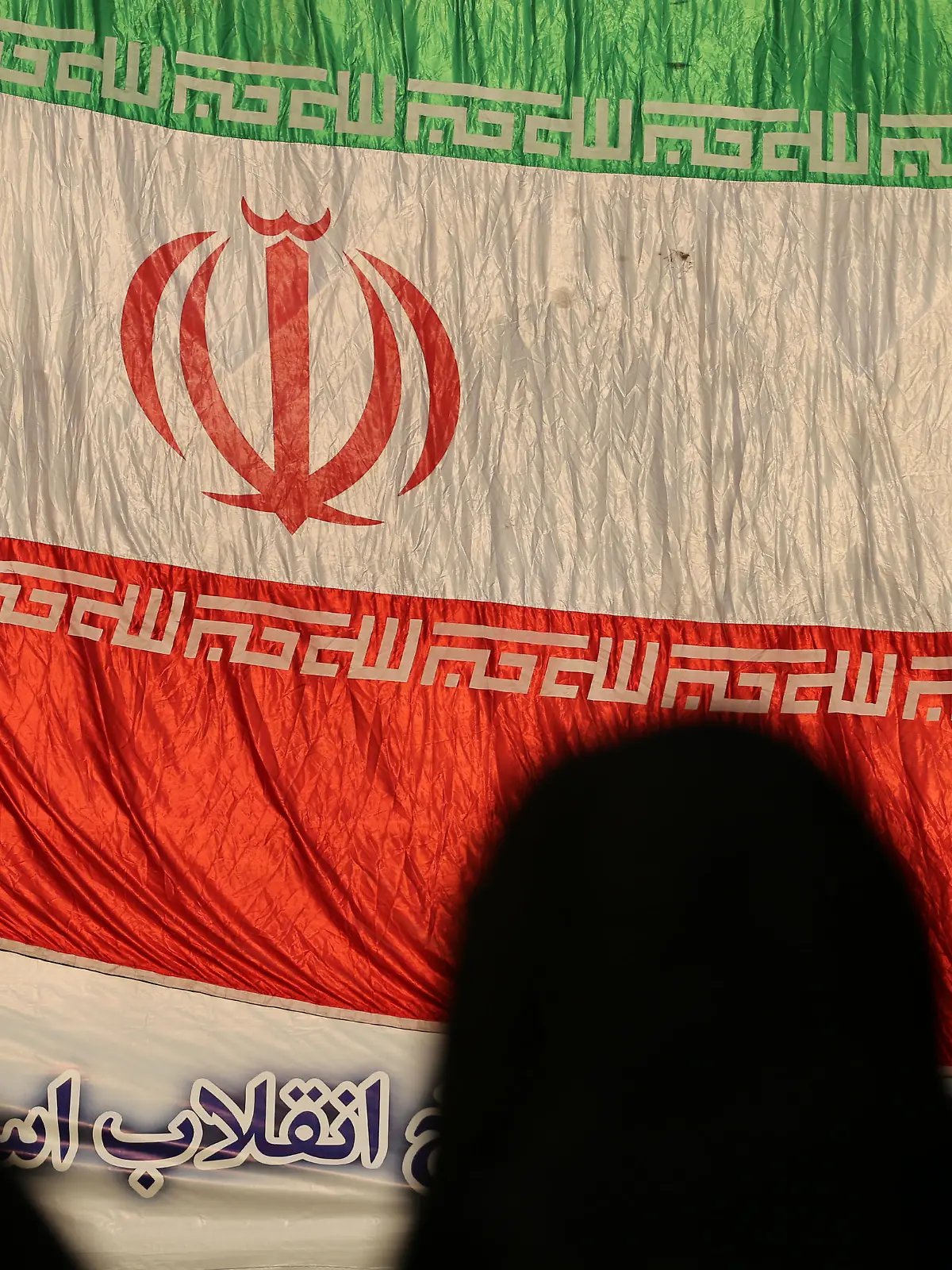 December 29, 2022, Tehran, Tehran, Iran: Three veiled women stand in front of the Iranian flag during the Dey 9 anniversary rally at Imam Hossein Square in downtown Tehran, Iran, on December 29, 2022. On 30 December 2009, pro-government rallies, also known as the Dey 9 epic, took place in various Iranian cities, including Tehran, Shiraz, Arak, Qom and Isfahan. The rallies were hold in response to the Ashura protests, where protesters on that day did acts including applauding, whistling, and engaging in other cheerful displays, which was viewed as violation of a red line and targeting Husayn ibn Ali and Ashura commemoration itself. The demonstrations and counter-demonstrations were connected to the disputed 2009 Iranian presidential election. (Credit Image: © Rouzbeh Fouladi via ZUMA Press Wire) / action press
