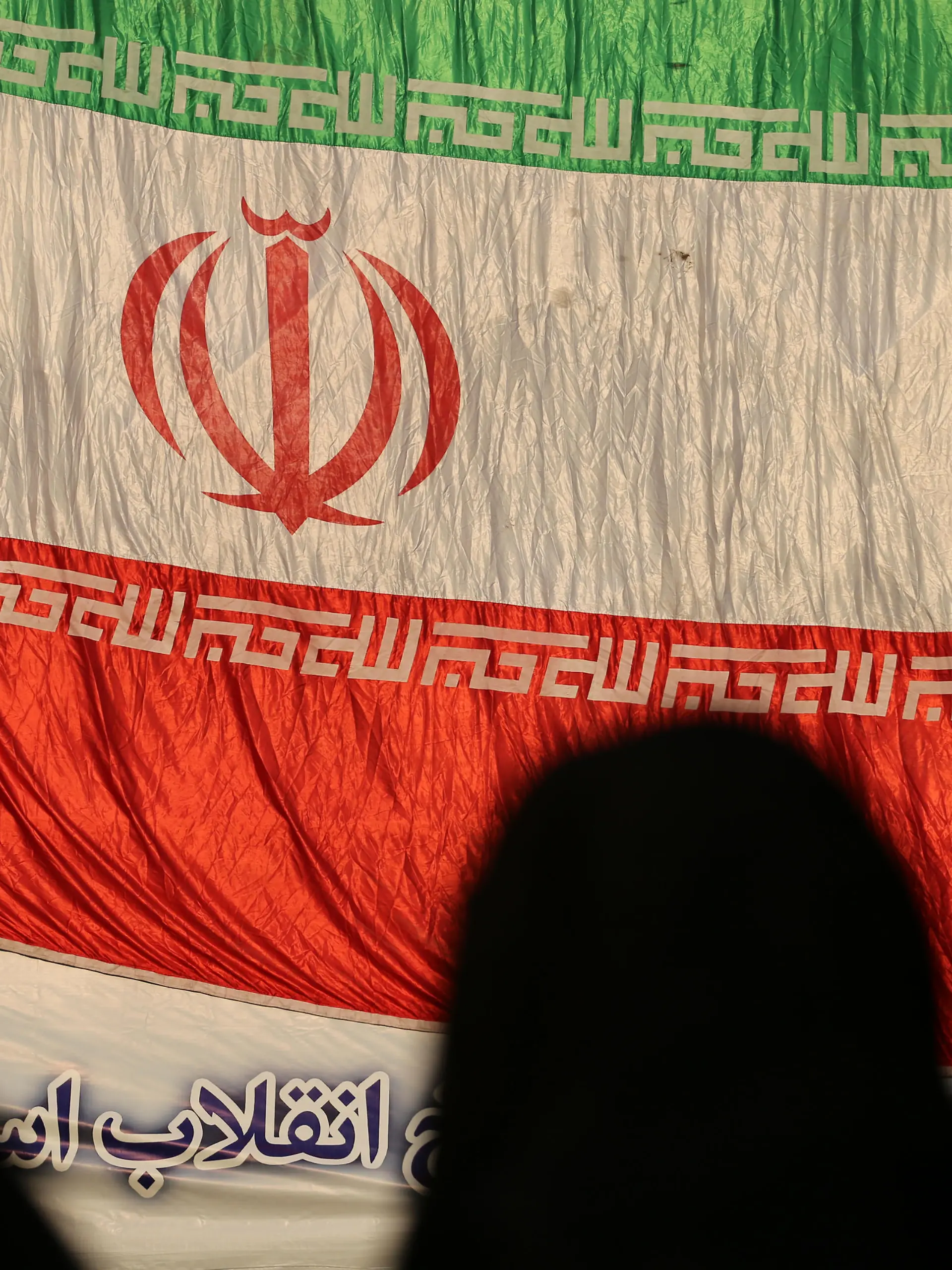 December 29, 2022, Tehran, Tehran, Iran: Three veiled women stand in front of the Iranian flag during the Dey 9 anniversary rally at Imam Hossein Square in downtown Tehran, Iran, on December 29, 2022. On 30 December 2009, pro-government rallies, also known as the Dey 9 epic, took place in various Iranian cities, including Tehran, Shiraz, Arak, Qom and Isfahan. The rallies were hold in response to the Ashura protests, where protesters on that day did acts including applauding, whistling, and engaging in other cheerful displays, which was viewed as violation of a red line and targeting Husayn ibn Ali and Ashura commemoration itself. The demonstrations and counter-demonstrations were connected to the disputed 2009 Iranian presidential election. (Credit Image: © Rouzbeh Fouladi via ZUMA Press Wire) / action press