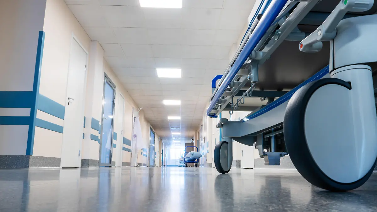 Medical bed on wheels in the hospital corridor. View from below.