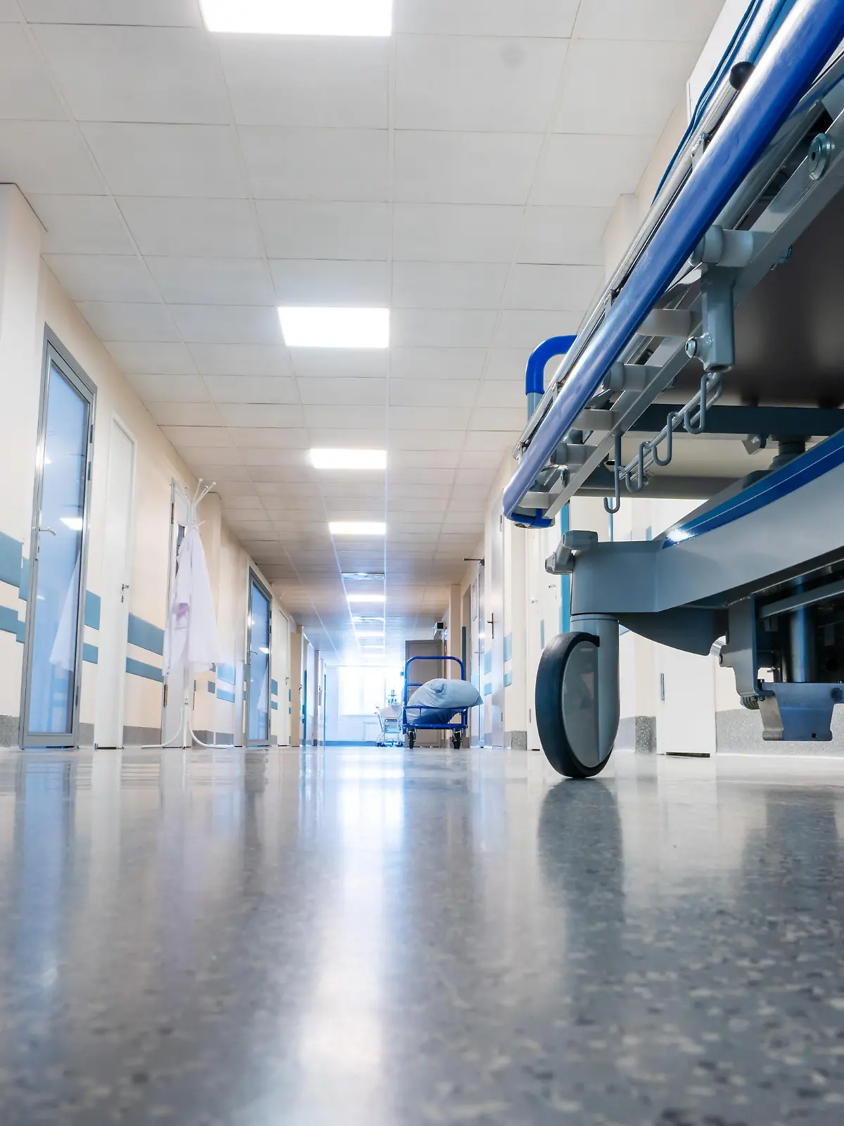 Medical bed on wheels in the hospital corridor. View from below.