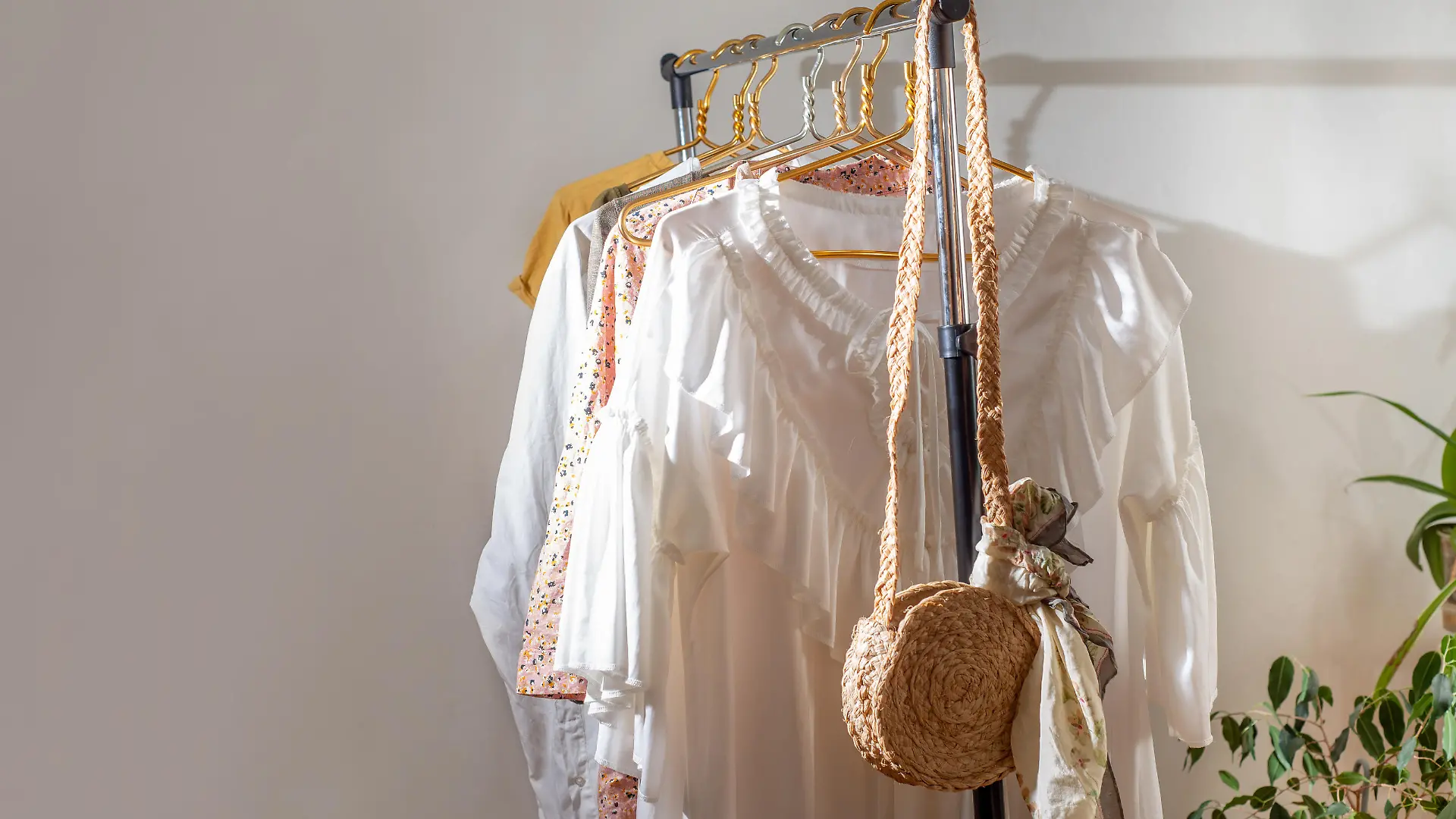 Second-hand clothes on the rail. The concept of sustainable economic life. Sale of clothes. Summer women's clothing on the swap. Clothing store