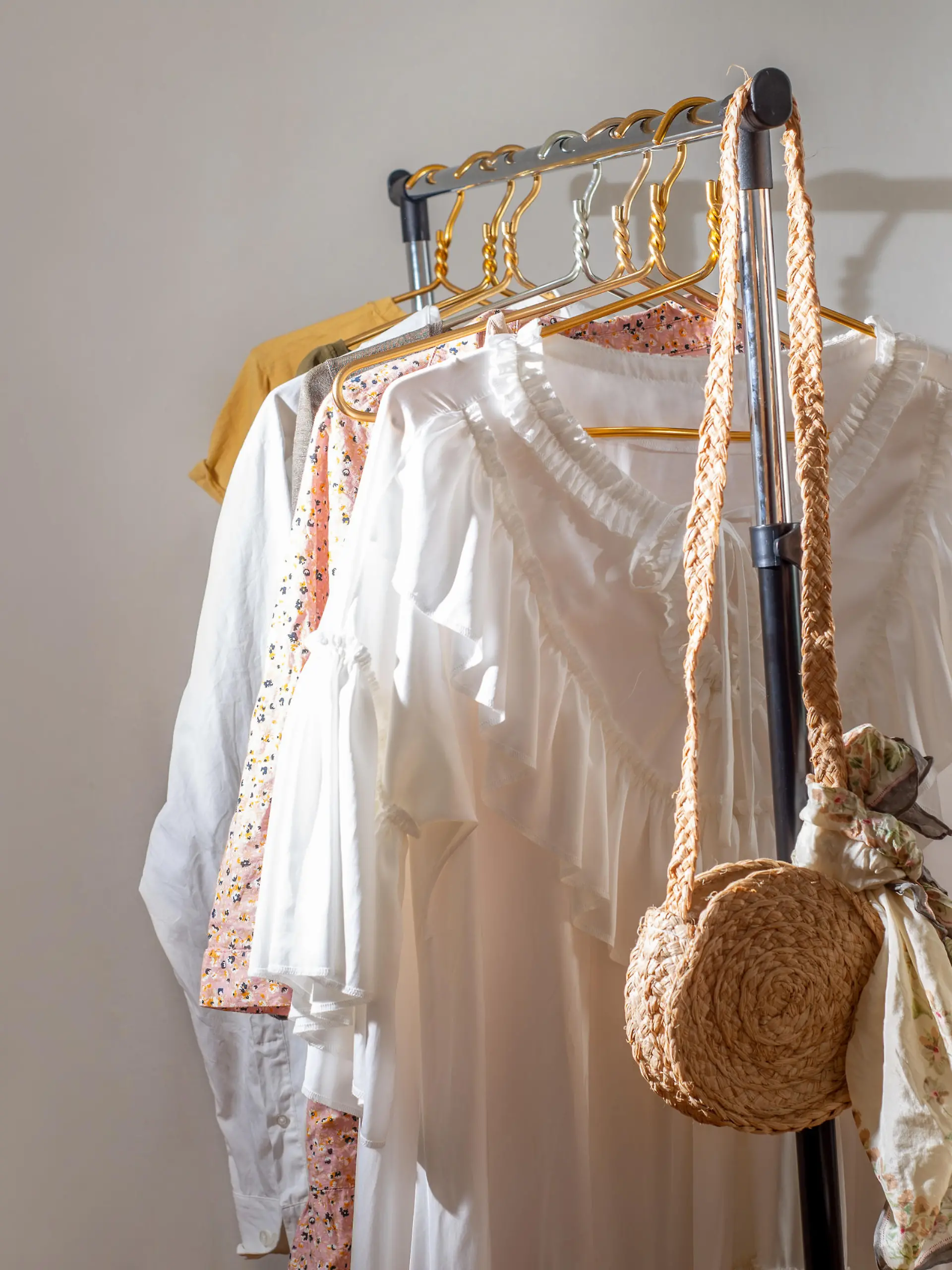 Second-hand clothes  on the rail. The concept of sustainable economic life. Sale of clothes. Summer women's clothing on the swap. Clothing store