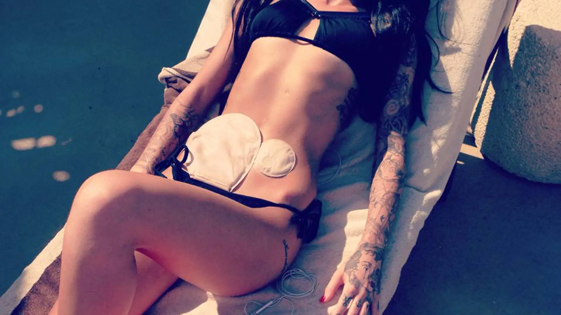 PIC FROM CATERS NEWS - (PICTURED: The picture that got loads of likes) - A stunning brunette has become an INTERNET SENSATION after bravely posting a BIKINI snap online which exposed her COLOSTOMY BAGS. The photo - which shows the first time Bethany Townsend, 23, dared to bare after being fitted with two colostomy bags - has now been viewed be over an incredible NINE MILLION people. Bethany, a make-up artist from Worcester, has been so overwhelmed by the response that she now feels confident enough to pursue her dream career of becoming a model. SEE CATERS COPY.