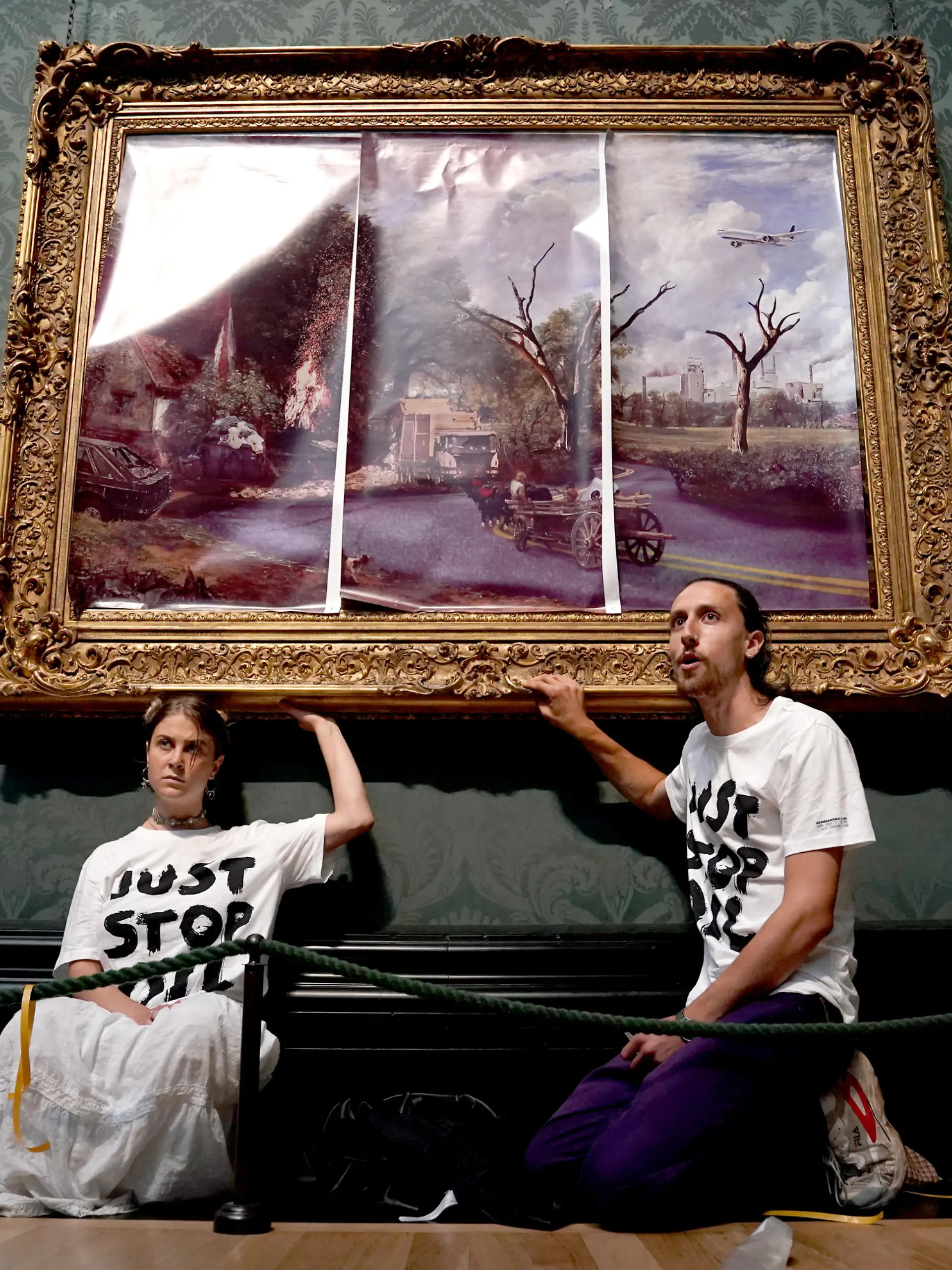 Eco-protesters court case. File photo dated 04/07/22 of protesters from Just Stop Oil climate protest group, who glued their hands to the frame of John Constable's The Hay Wain after first having covered the painting with their own picture at the National Gallery, London. Hannah Hunt and Eden Lazarus have appeared at Westminster Magistrates' Court charged with causing criminal damage to The Hay Wain painting and frame at the National Gallery. Issue date: Tuesday December 6, 2022. See PA story COURTS Oil. Photo credit should read: Kirsty O'Connor/PA Wire URN:70132281