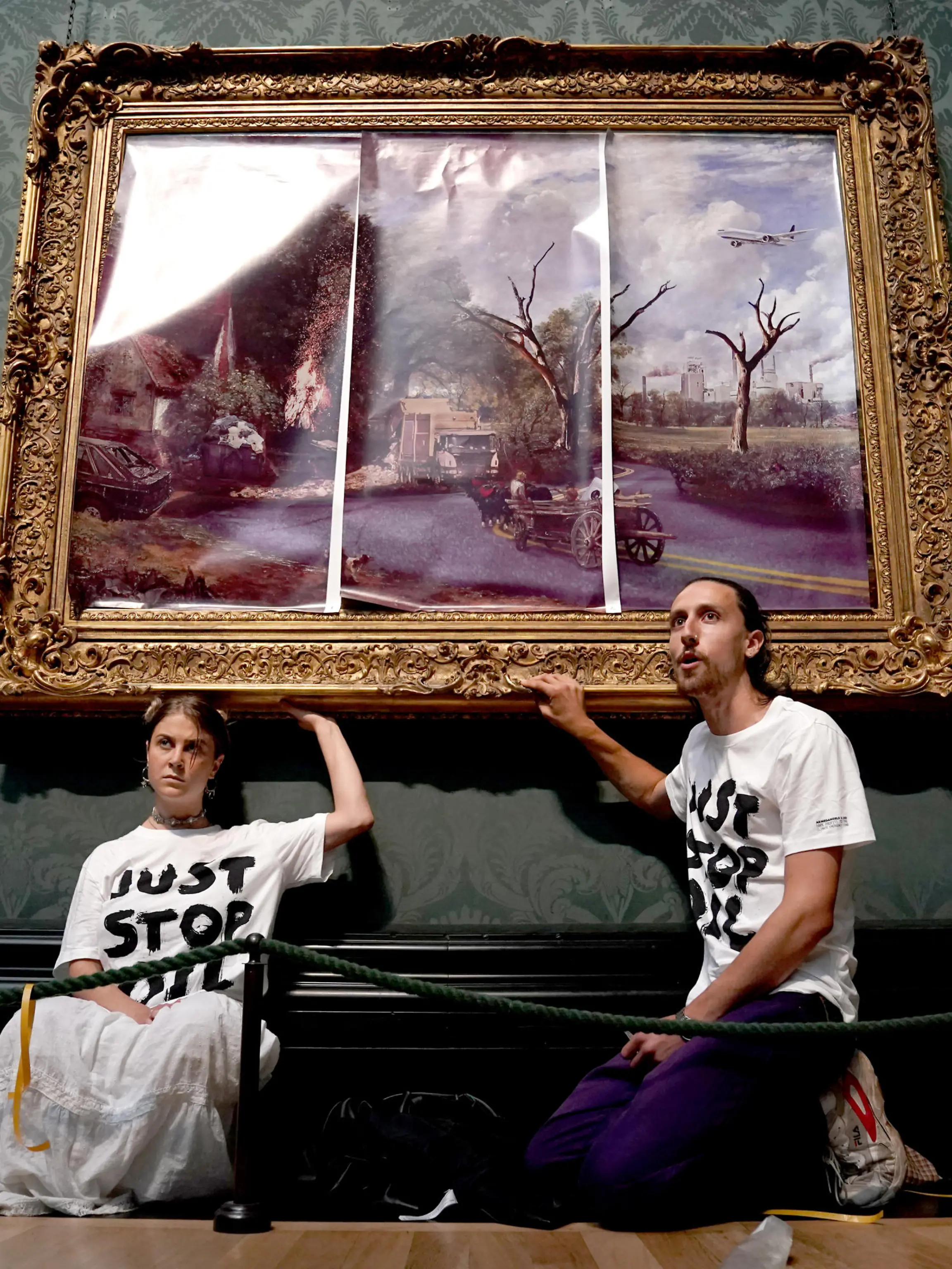 Eco-protesters court case. File photo dated 04/07/22 of protesters from Just Stop Oil climate protest group, who glued their hands to the frame of John Constable's The Hay Wain after first having covered the painting with their own picture at the National Gallery, London. Hannah Hunt and Eden Lazarus have appeared at Westminster Magistrates' Court charged with causing criminal damage to The Hay Wain painting and frame at the National Gallery. Issue date: Tuesday December 6, 2022. See PA story COURTS Oil. Photo credit should read: Kirsty O'Connor/PA Wire URN:70132281